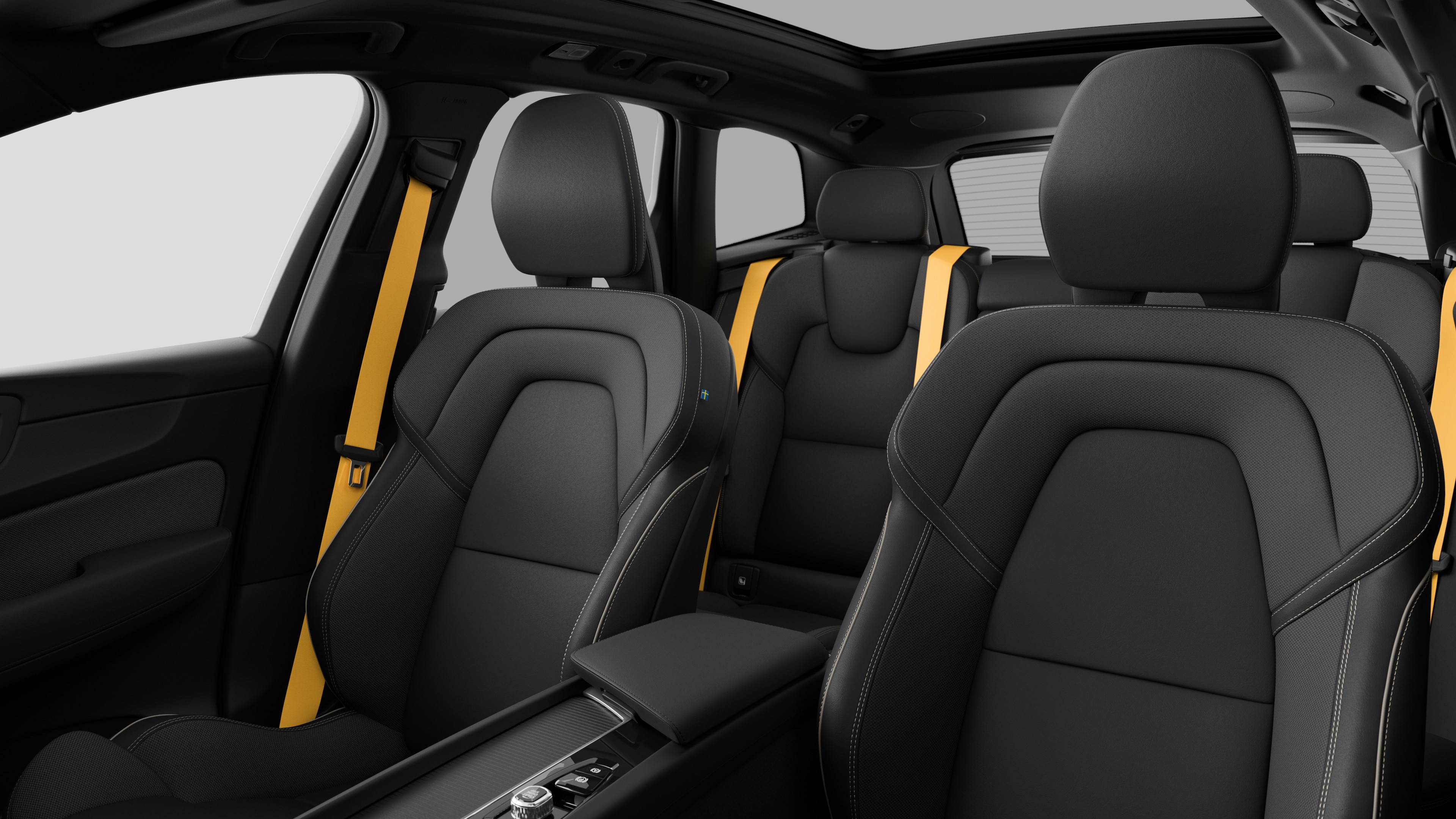 Volvo car interior showing rear passenger seats and center console in plain studio background.
