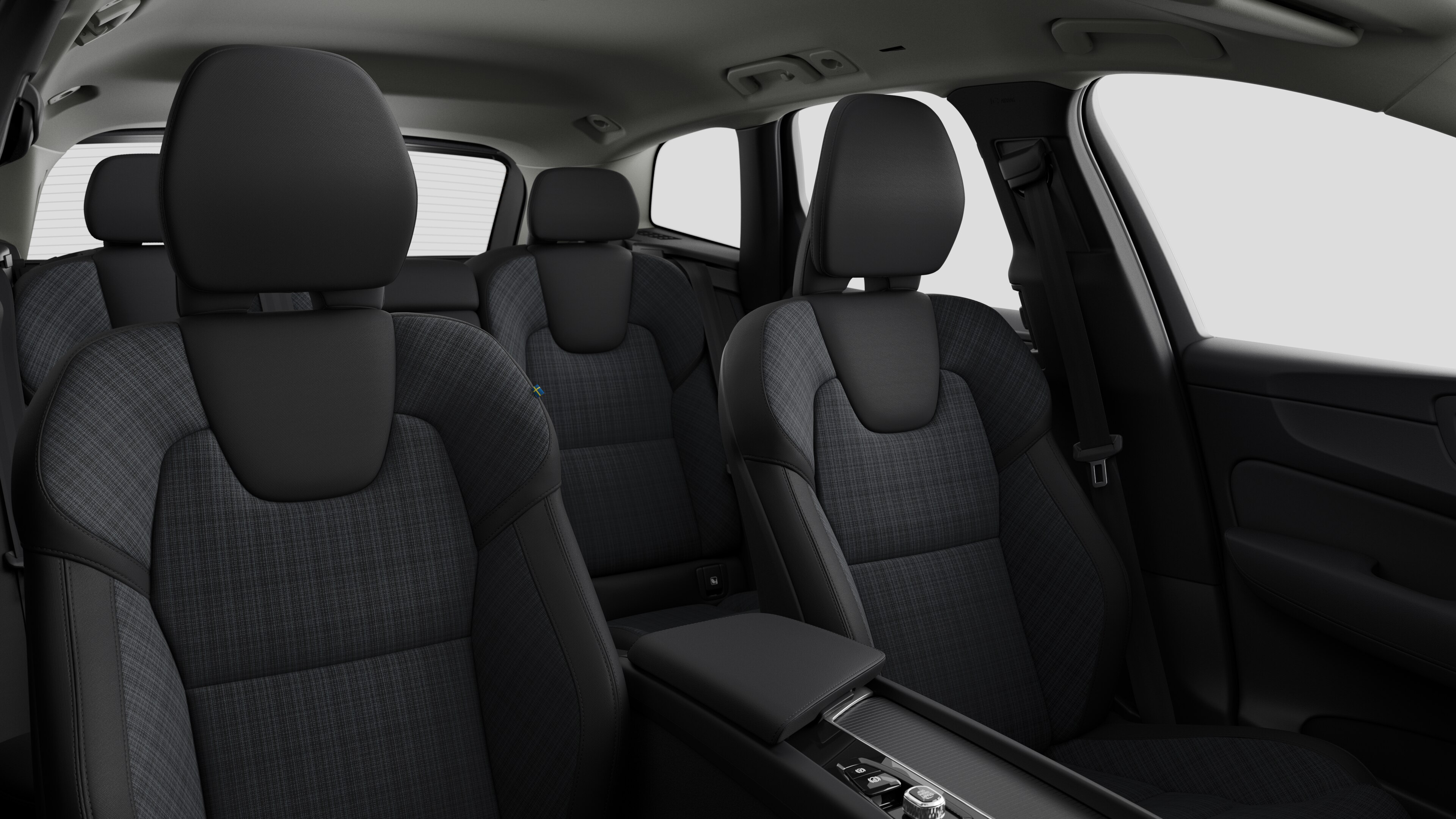 Volvo car interior showing rear passenger seats and center console in plain studio background.