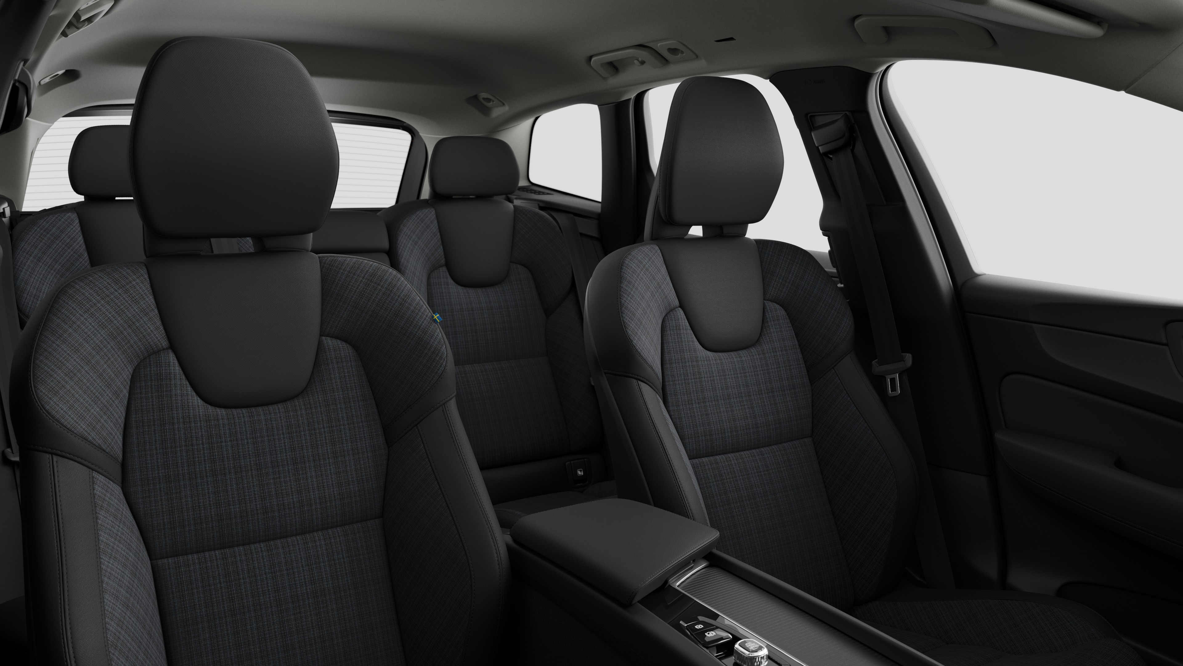 Volvo car interior showing rear passenger seats and center console in plain studio background.