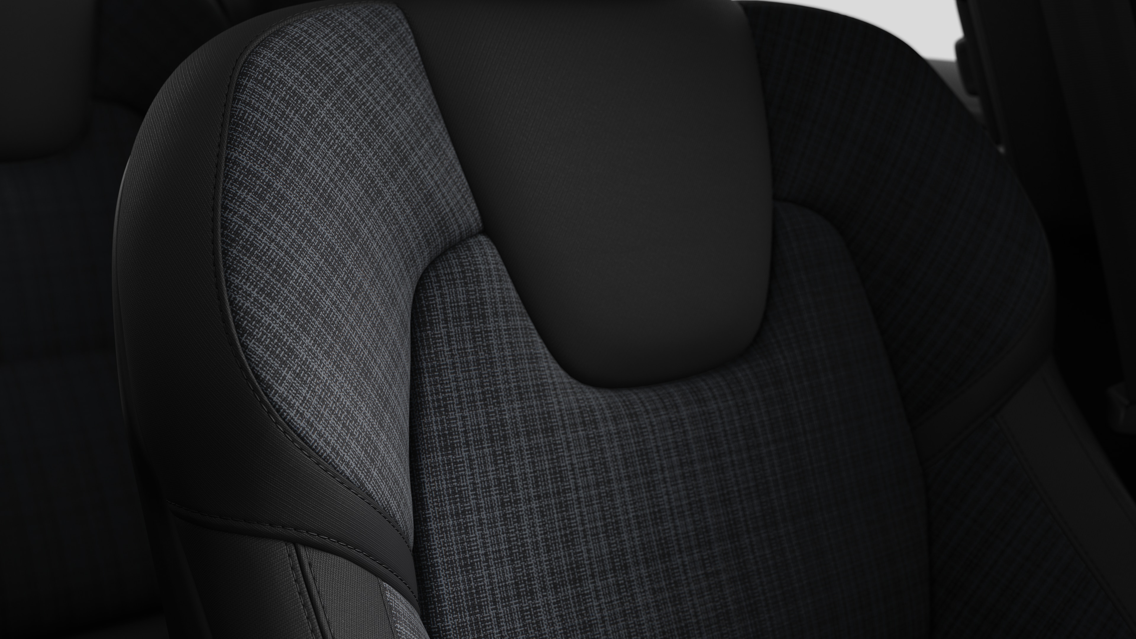 Close-up of Volvo car interior seat detail showing stitching and a small Swedish flag tag.