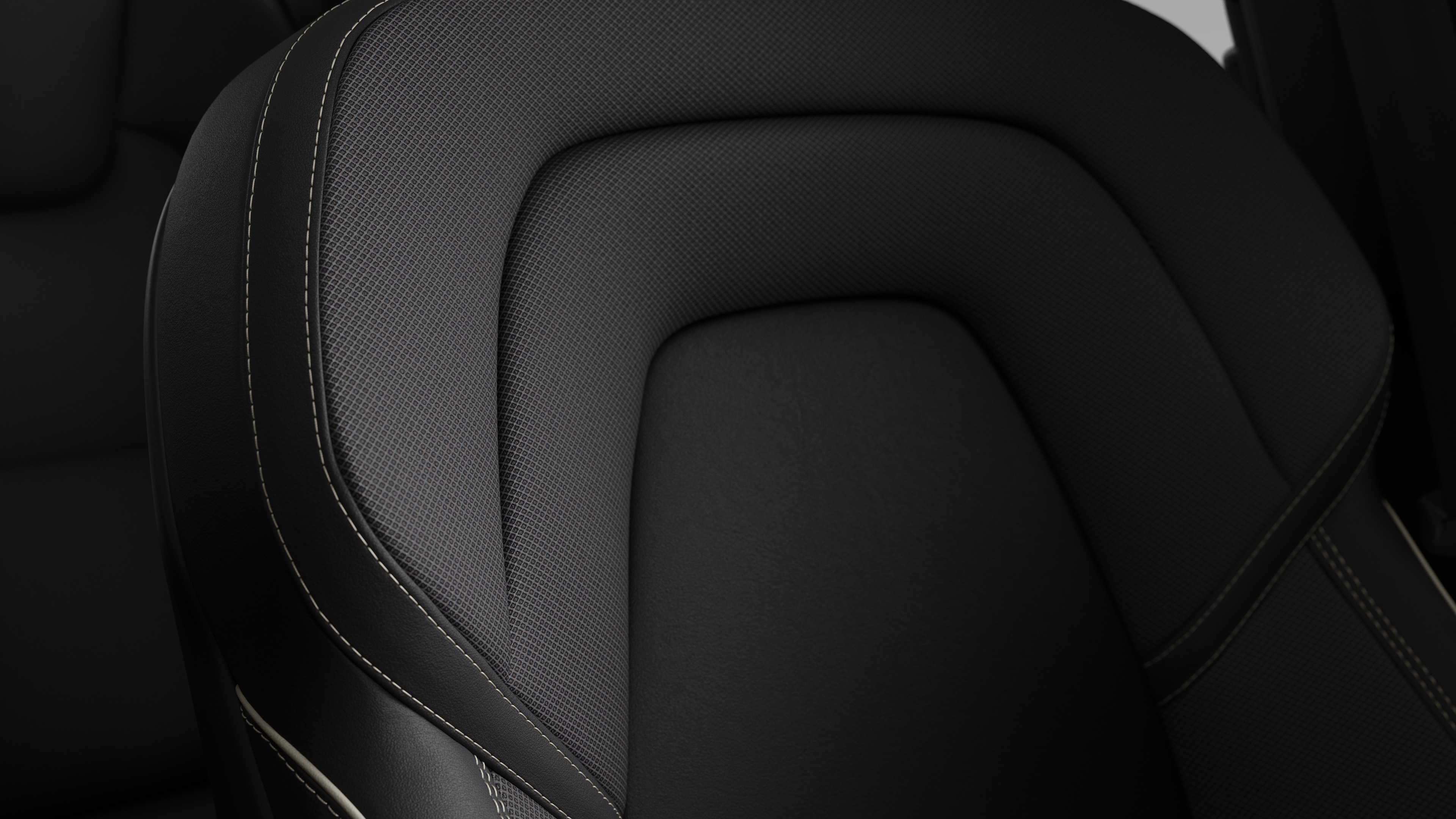 Close-up of Volvo car interior seat detail showing stitching and a small Swedish flag tag.