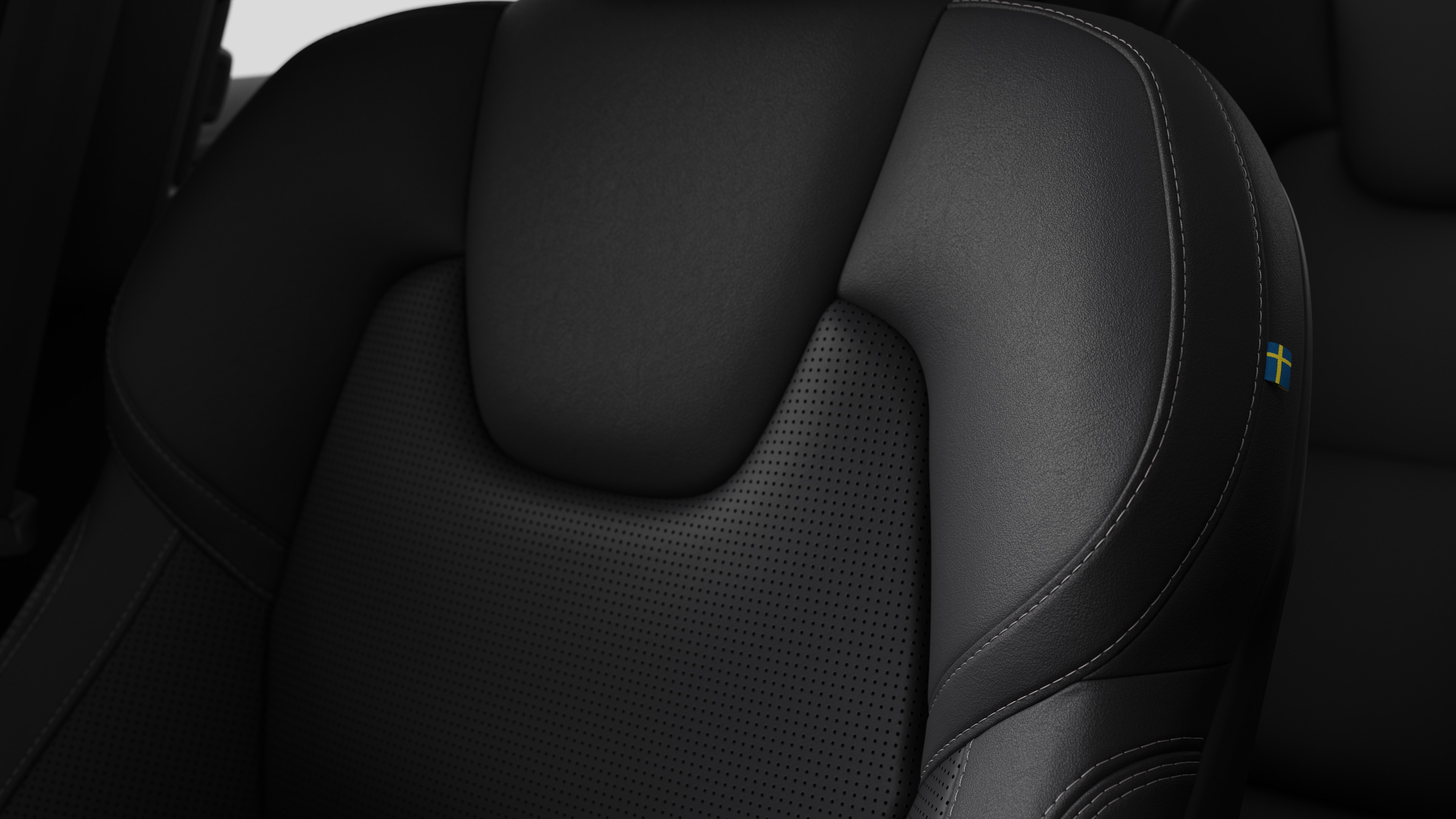 Cận cảnh chi tiết nội thất ghế ngồi của xe Volvo cho thấy đường khâu và một thẻ cờ Thụy Điển nhỏ.