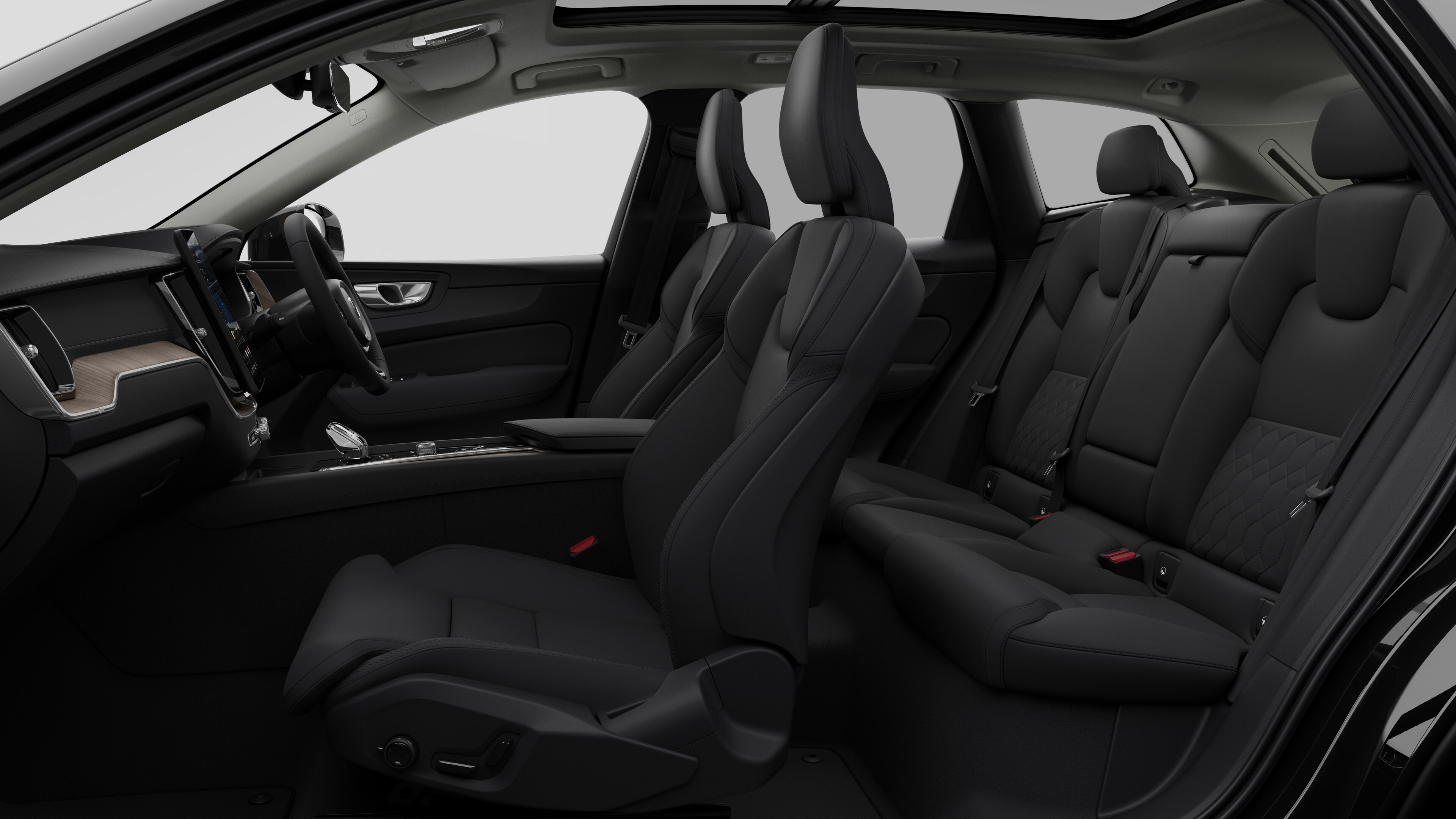 Volvo car interior side view showcasing front seats, rear passenger seats, steering wheel, dashboard, and center console, set against plain studio background.