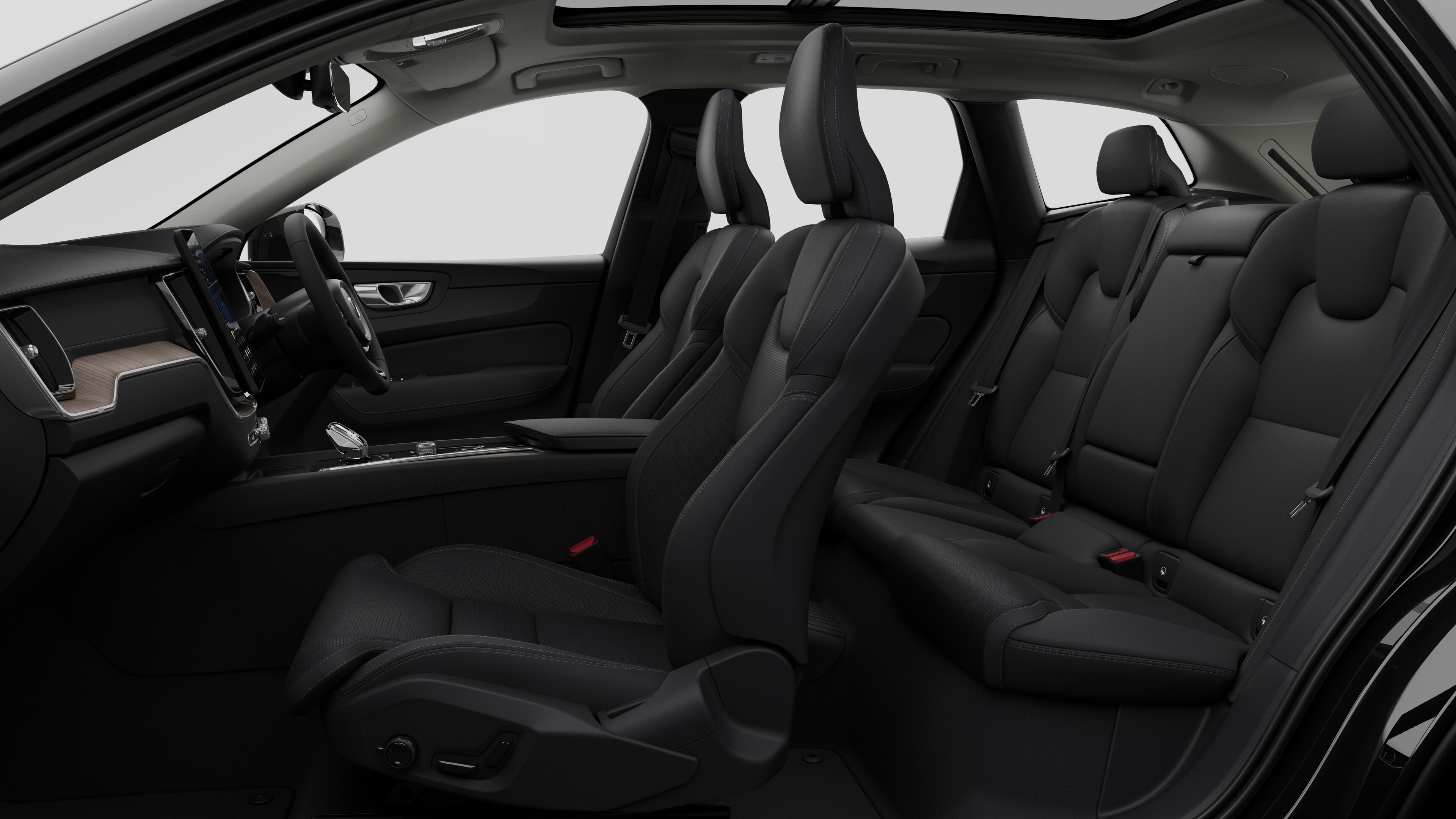 Volvo car interior side view showcasing front seats, rear passenger seats, steering wheel, dashboard, and center console, set against plain studio background.
