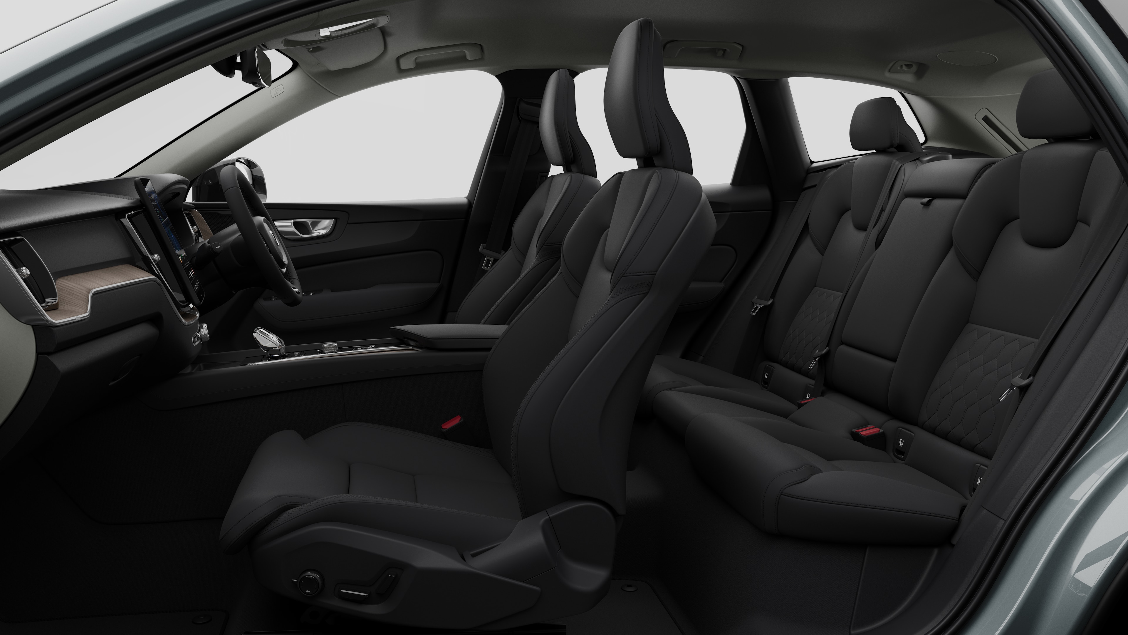Volvo car interior side view showcasing front seats, rear passenger seats, steering wheel, dashboard, and center console, set against plain studio background.
