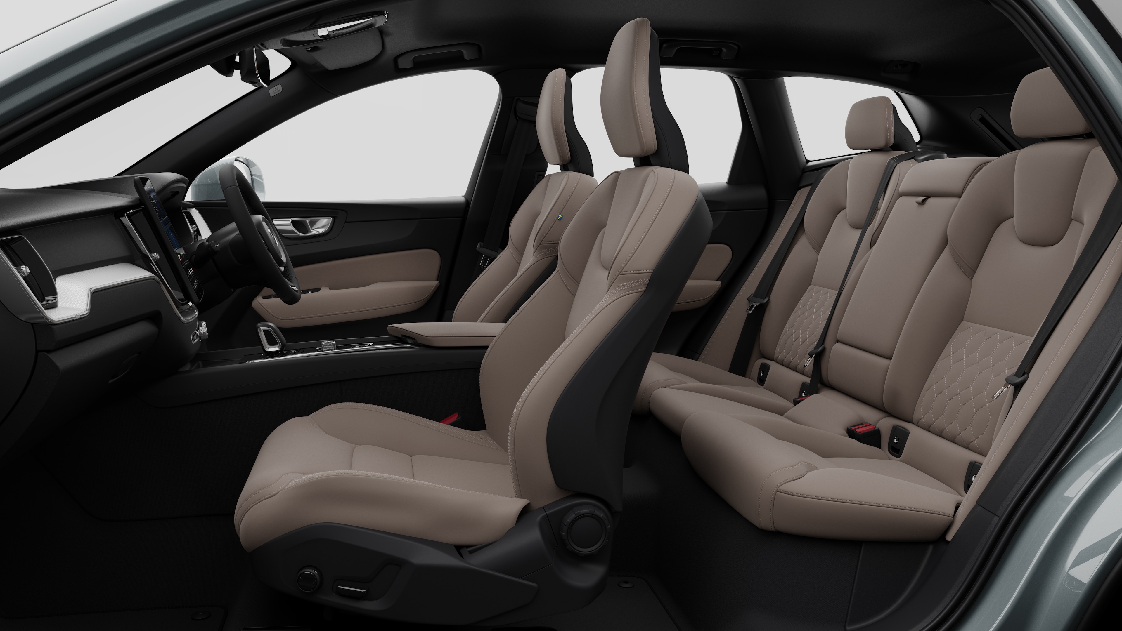 Volvo car interior side view showcasing front seats, rear passenger seats, steering wheel, dashboard, and centre console, set against plain studio background.