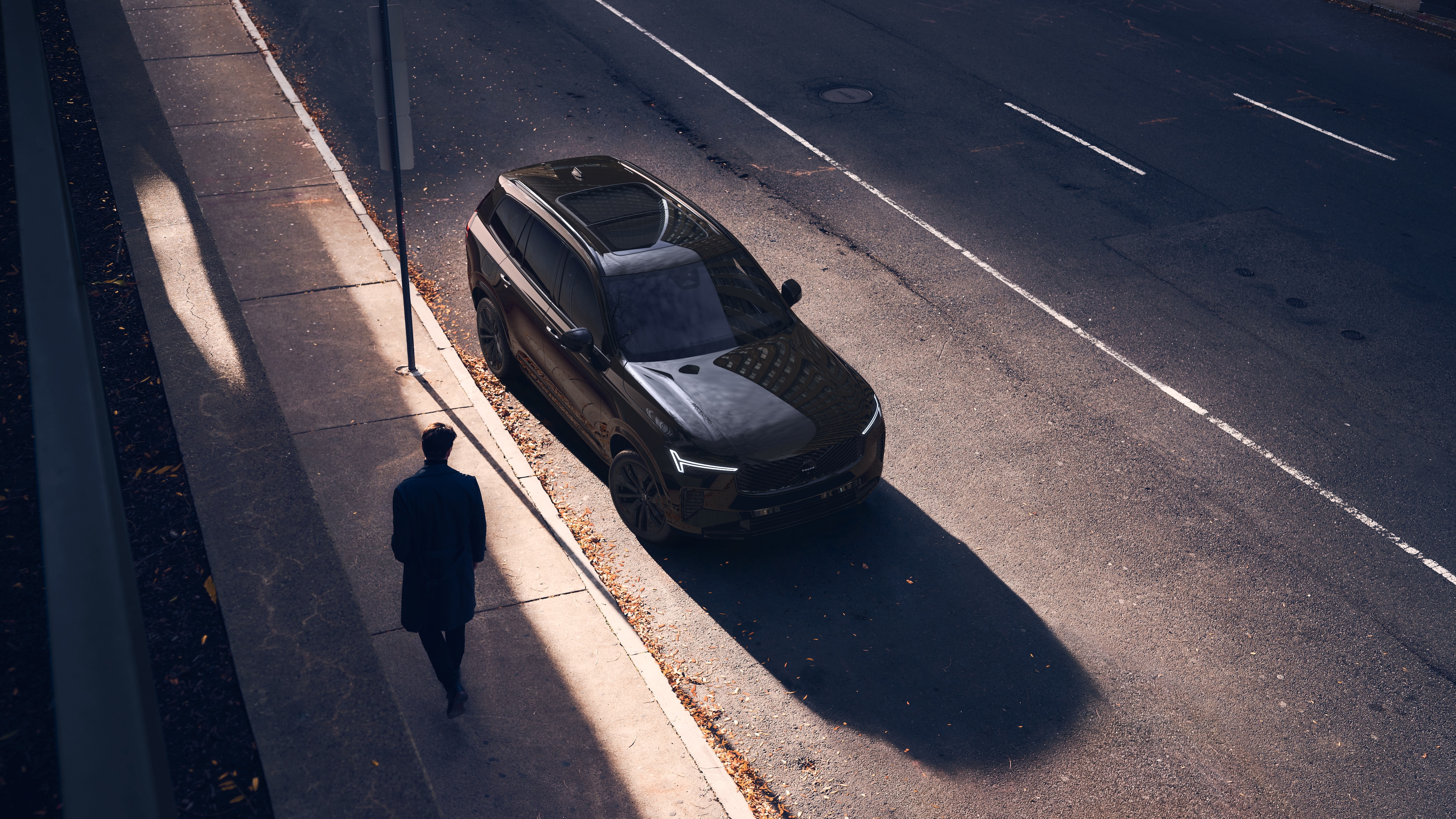 Volvo car exterior in three-quarter view on an urban street background, showing one side, roof, and part of the front.