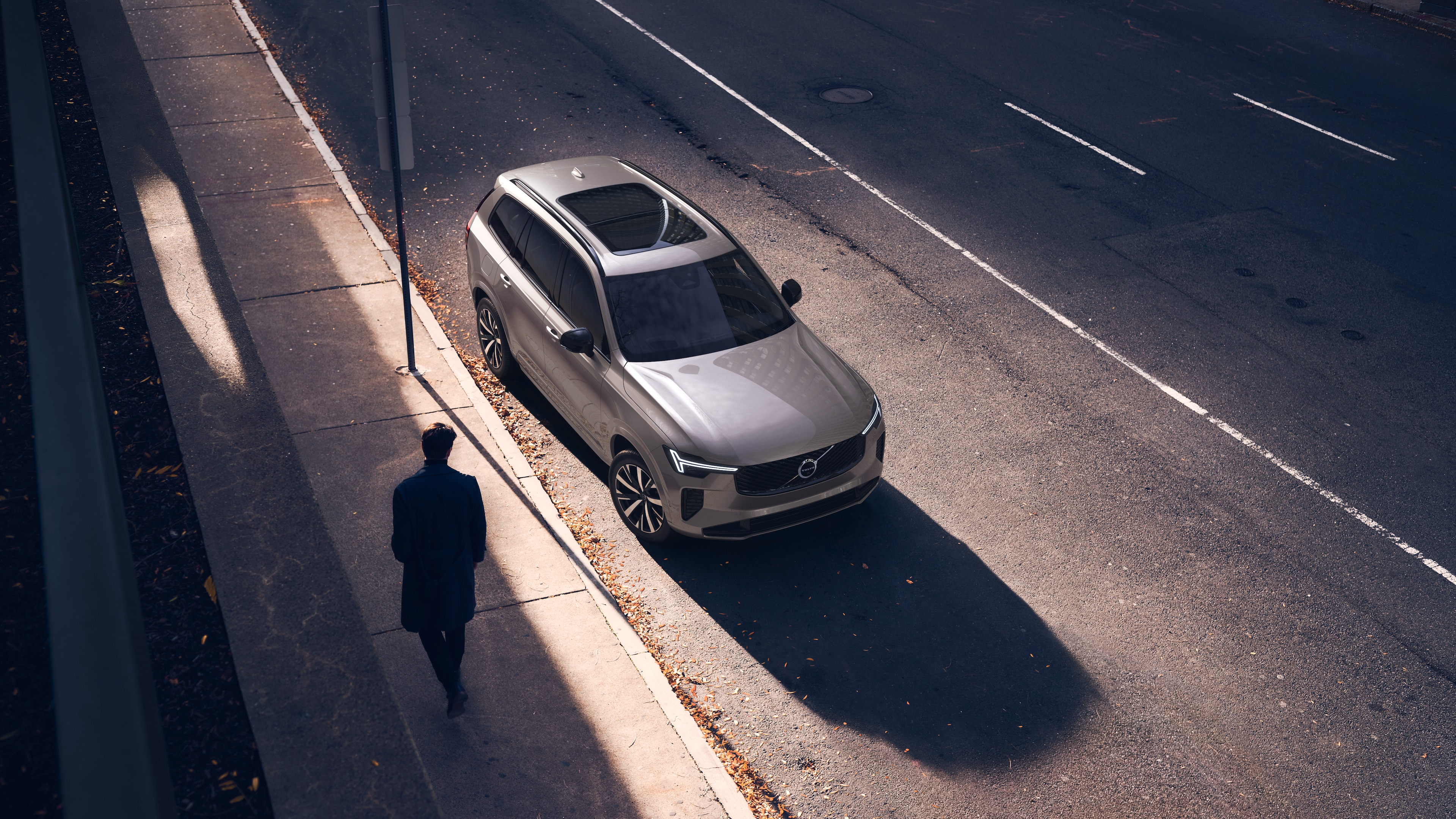 Volvo car exterior in three-quarter view on an urban street background, showing one side, roof, and part of the front.