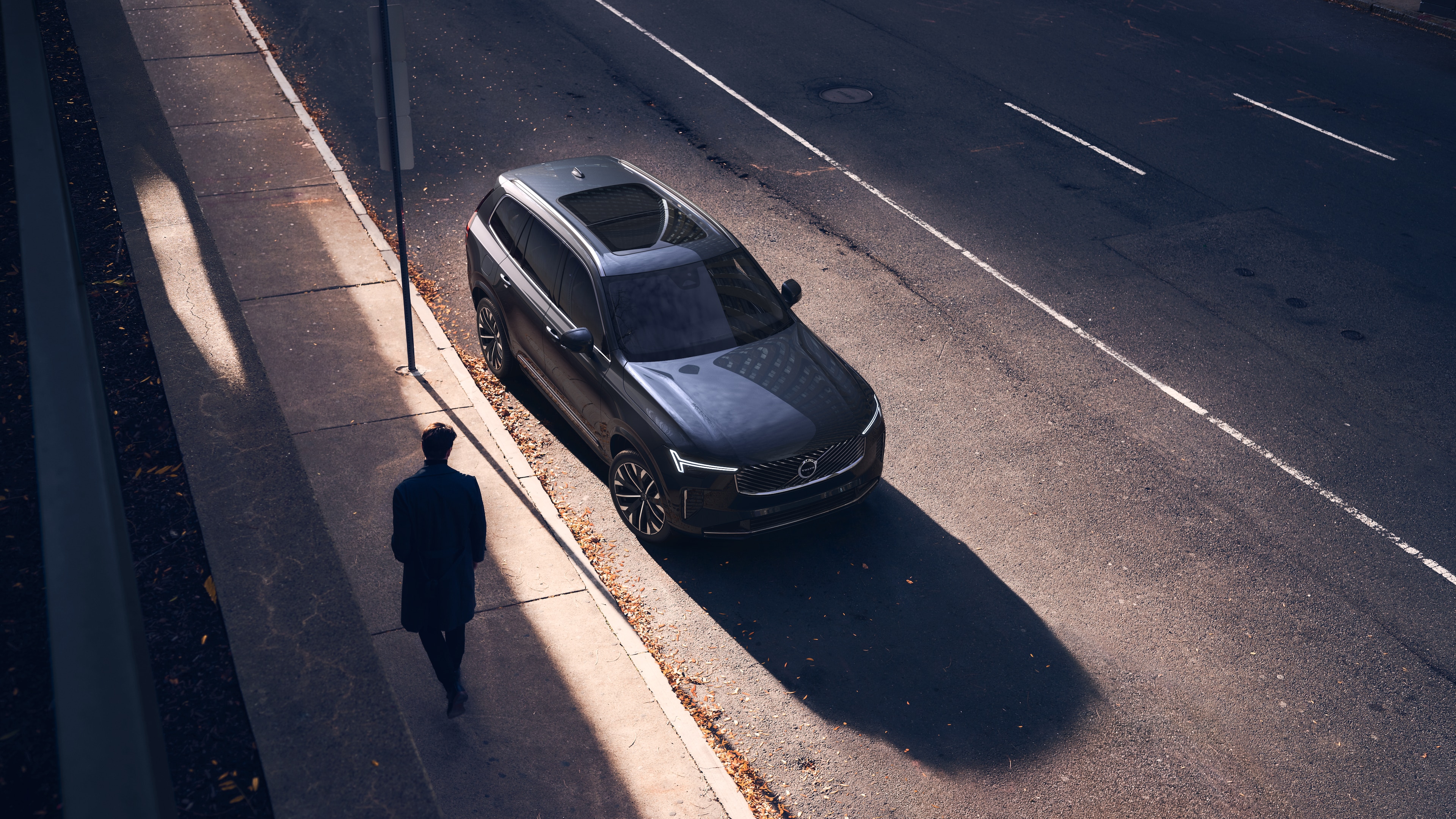 Volvo car exterior in three-quarter view on an urban street background, showing one side, roof, and part of the front.