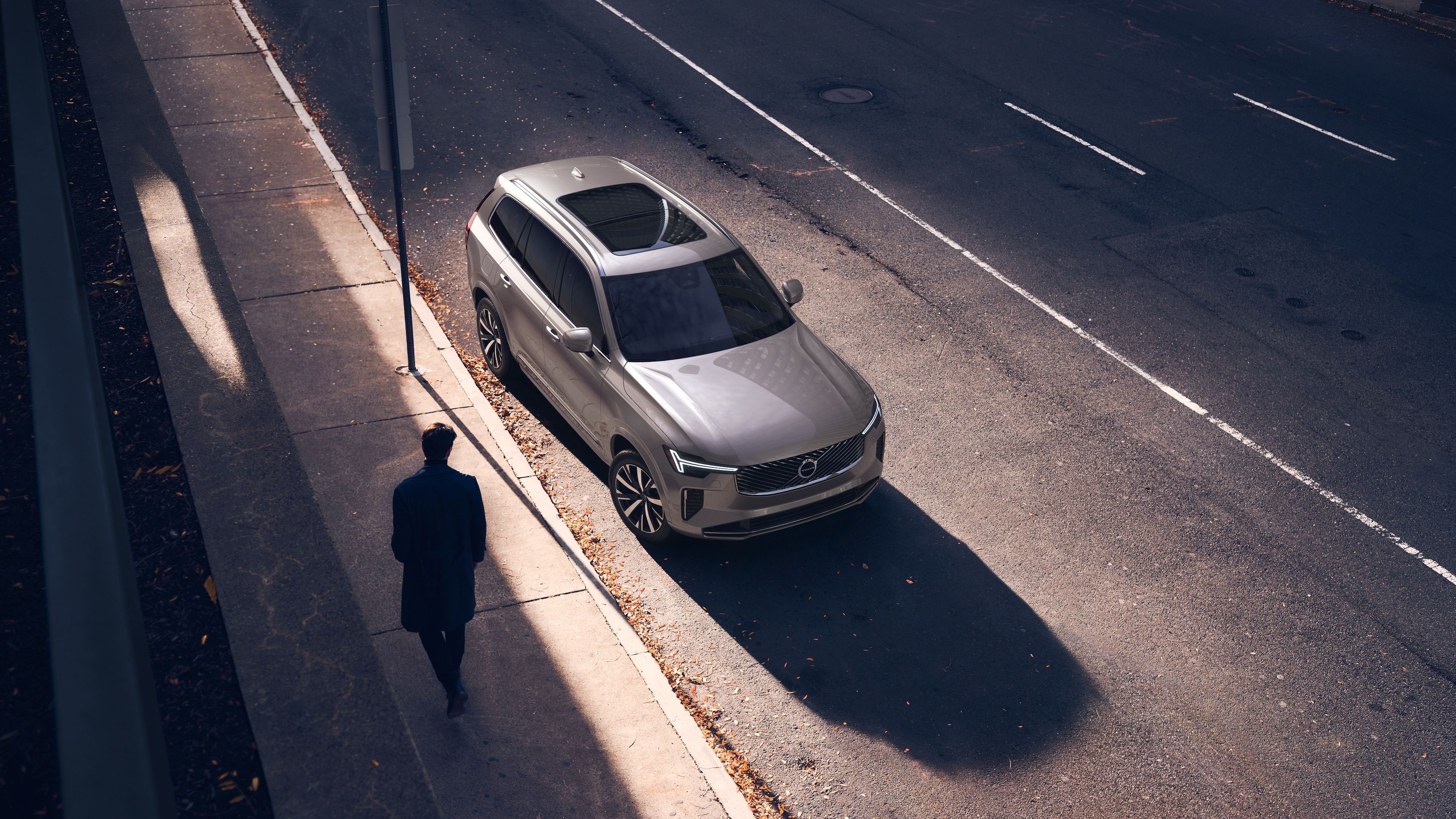 Volvo car exterior in three-quarter view on an urban street background, showing one side, roof, and part of the front.