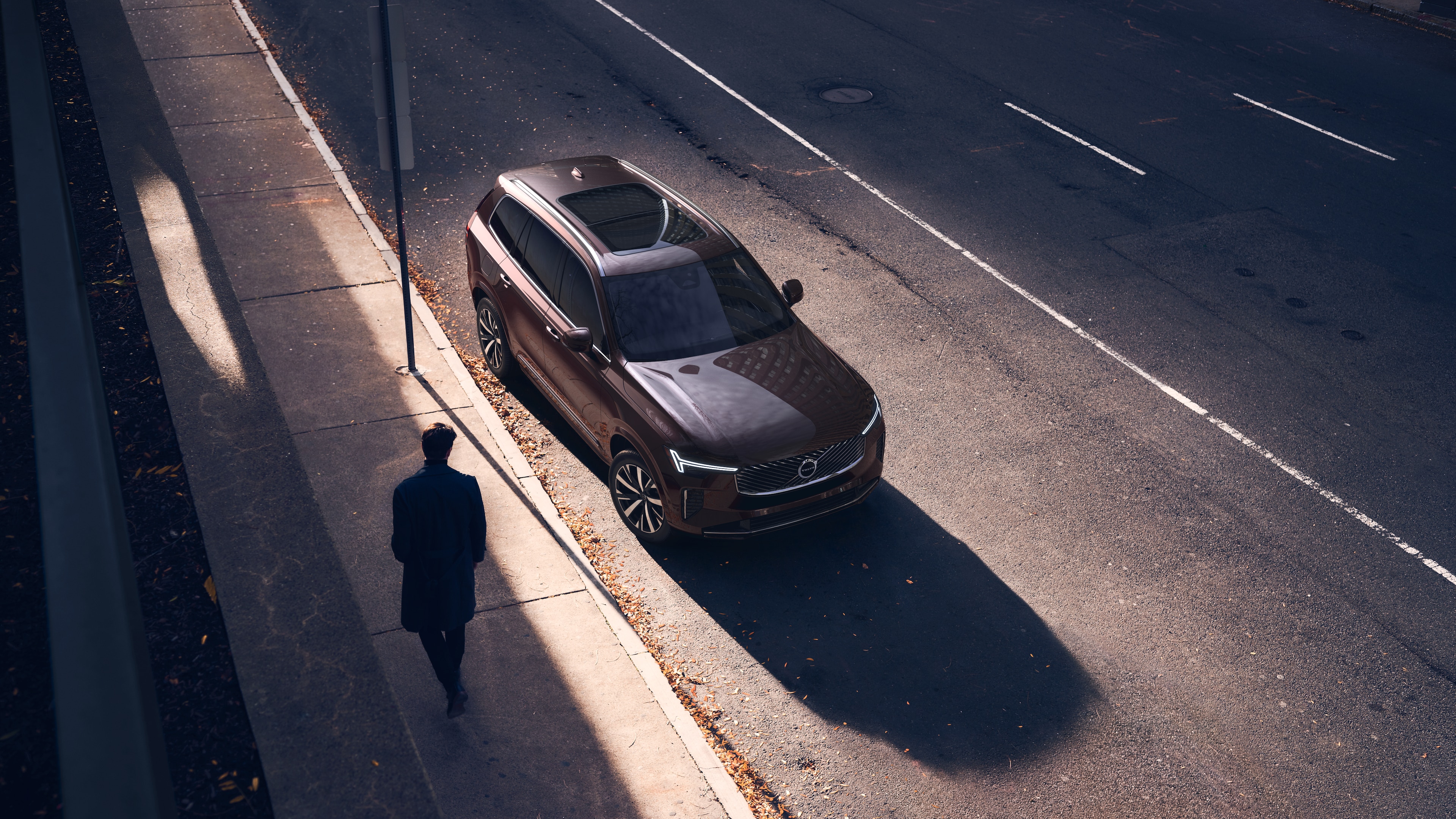 Volvo car exterior in three-quarter view on an urban street background, showing one side, roof, and part of the front.