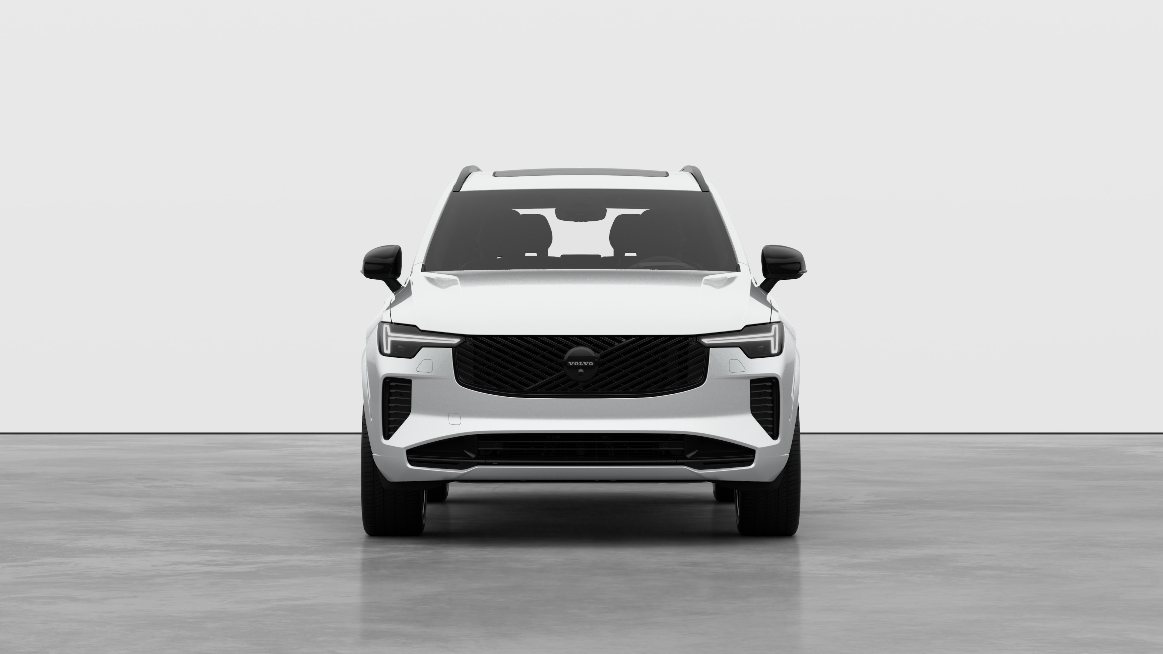 Widok samochodu Volvo z przodu na tle zwykłego studia