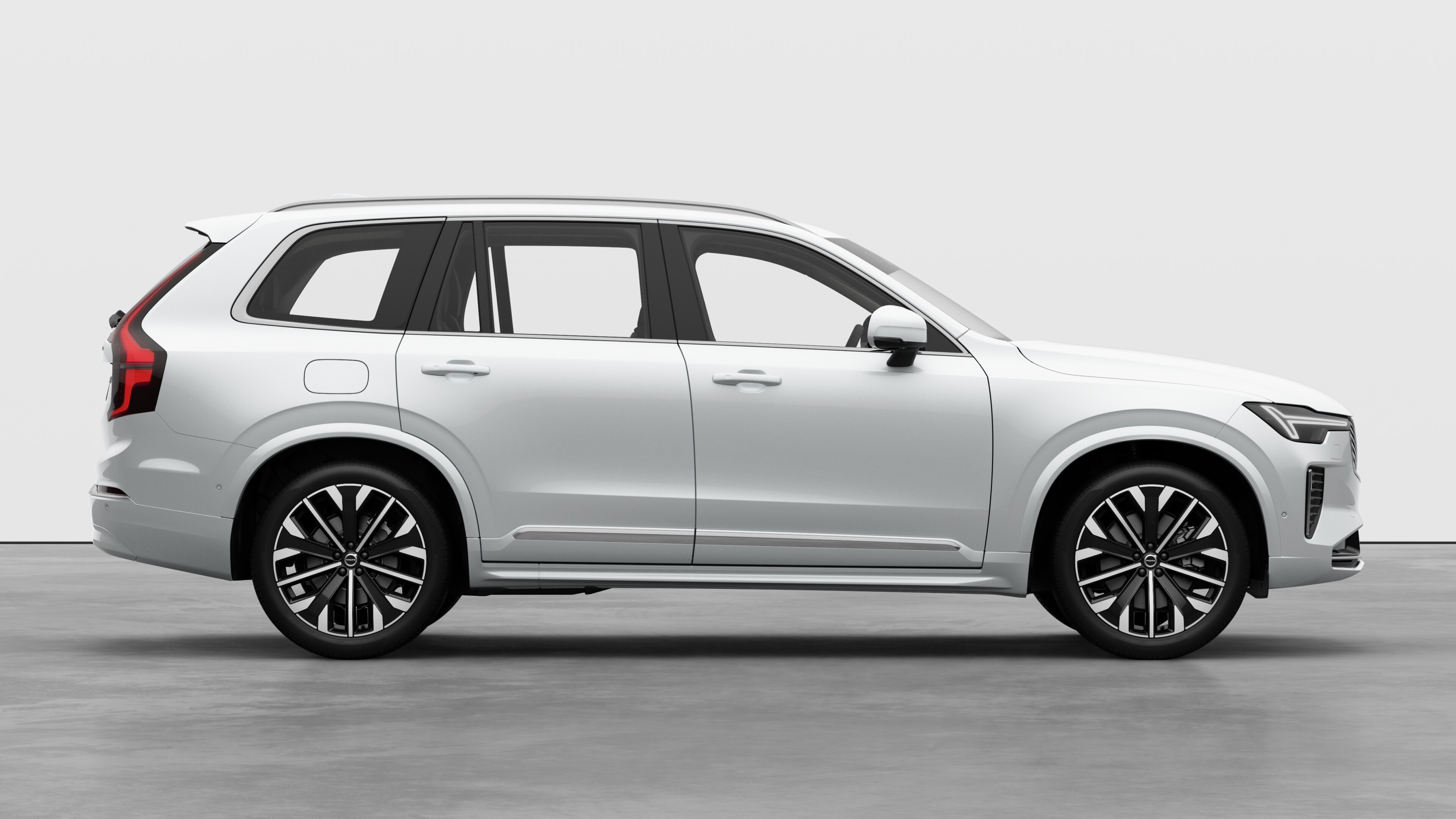 Vista laterale di un'auto Volvo sullo sfondo di uno studio che mostra le portiere chiuse e il design visibile delle ruote.