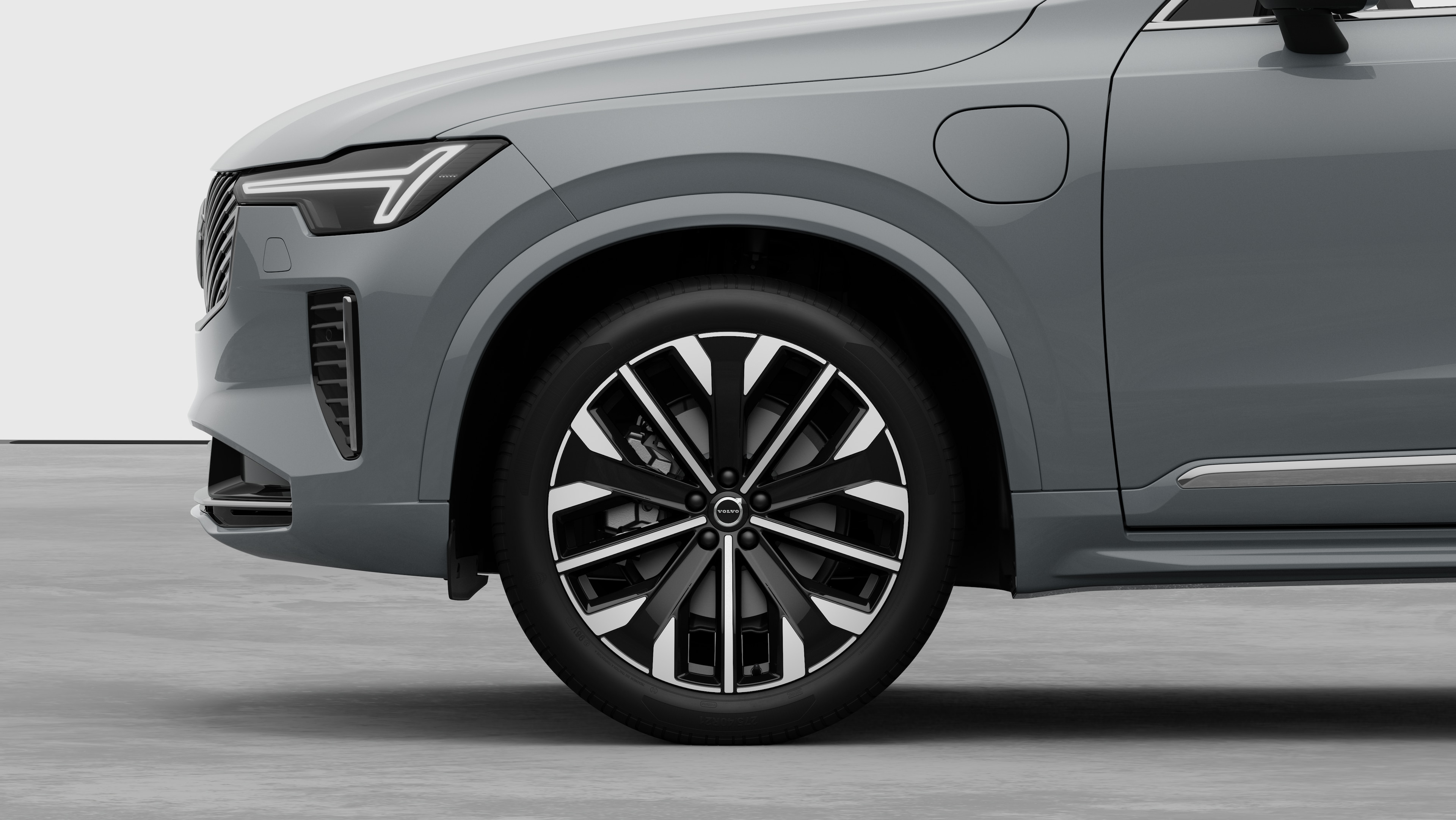 Volvo auto välimine külgvaade, mis keskendub esirattale ja porilauale tavalisel stuudiotaustal.