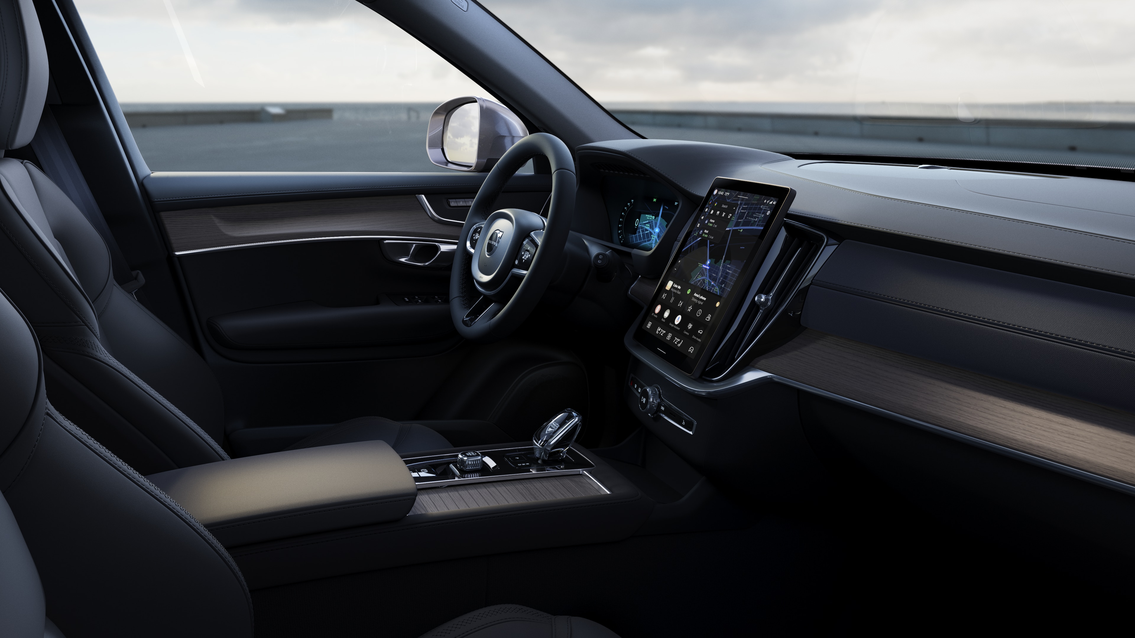 Volvo car interior showing dashboard, steering wheel, and center console with digital display in an open road background.