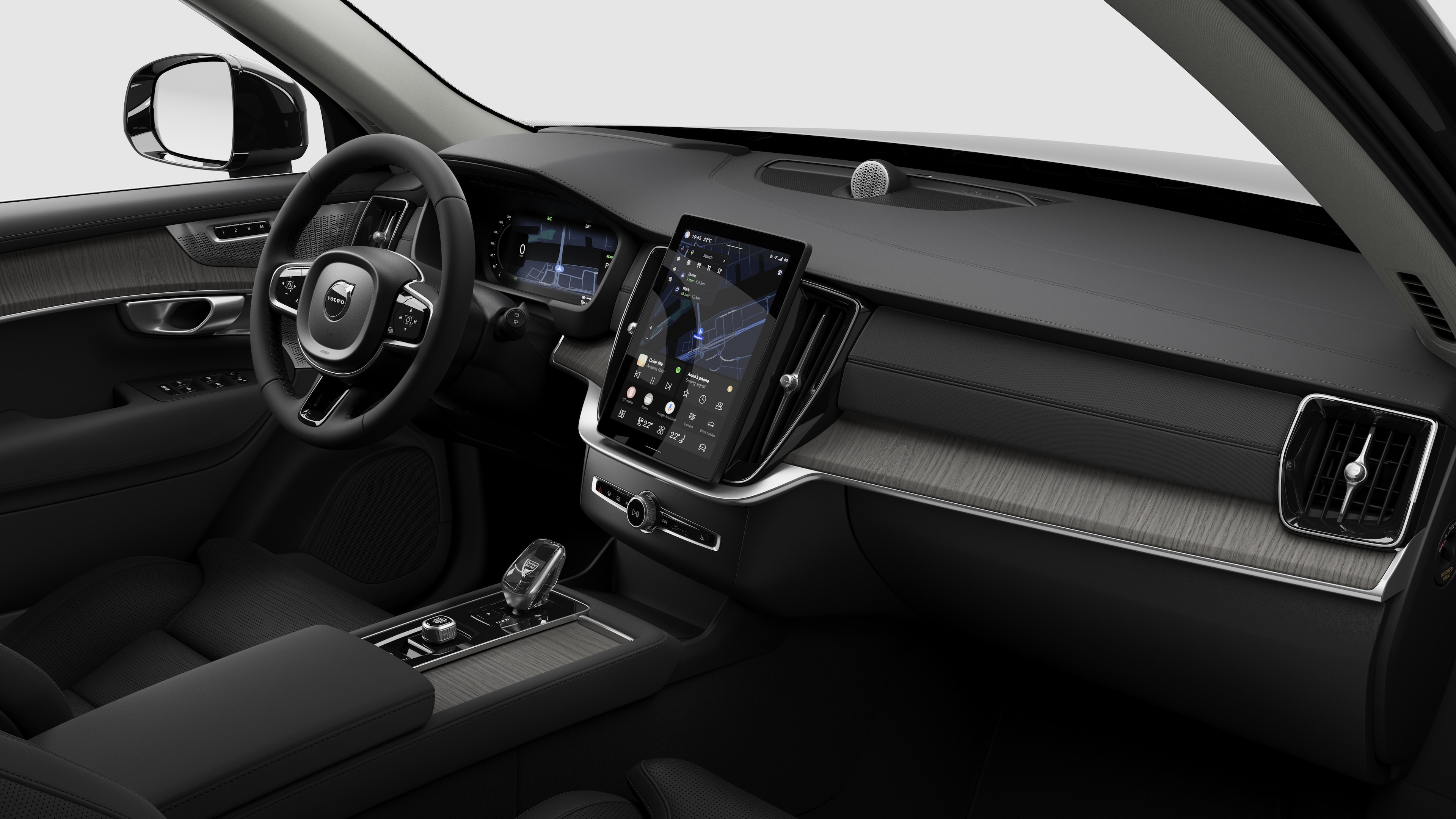 Hình ảnh nội thất của xe Volvo hiển thị bảng điều khiển, vô lăng, bảng điều khiển trung tâm và màn hình hiển thị kỹ thuật số trong nền studio đơn giản.