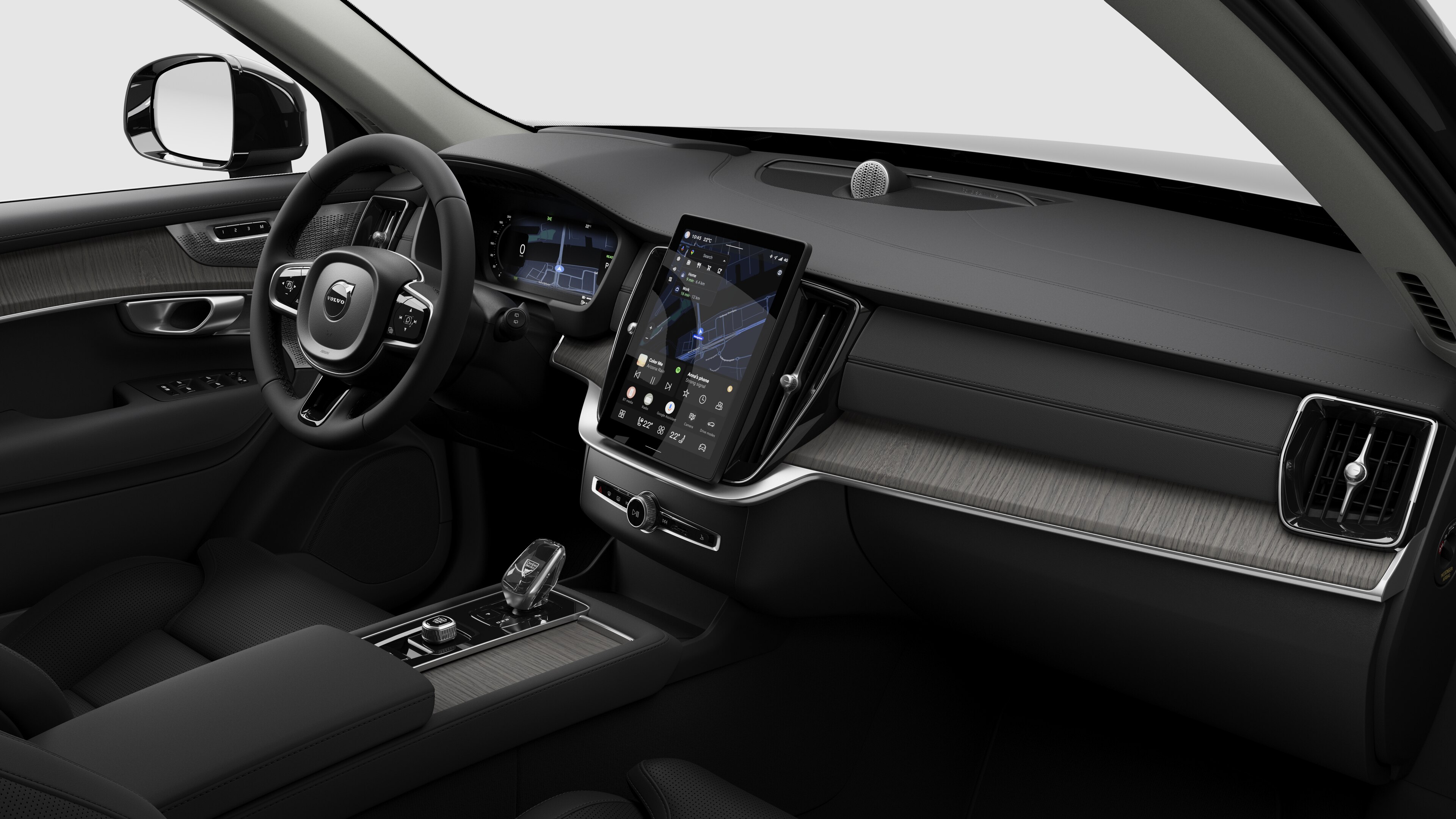 Hình ảnh nội thất của xe Volvo hiển thị bảng điều khiển, vô lăng, bảng điều khiển trung tâm và màn hình hiển thị kỹ thuật số trong nền studio đơn giản.