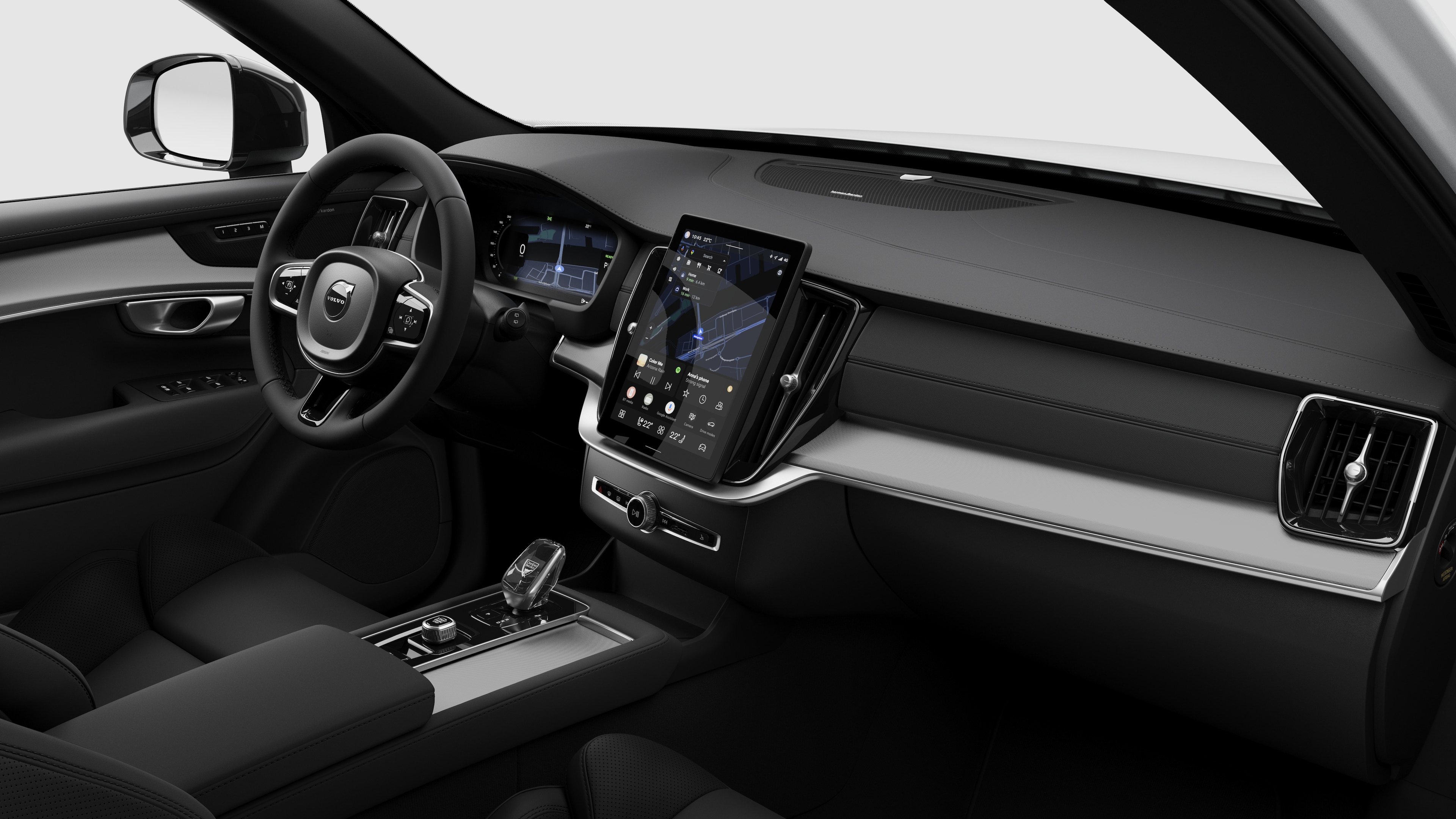 Innenansicht eines Volvo mit Armaturenbrett, Lenkrad, Mittelkonsole und digitalem Bildschirm in einem schlichten Studiohintergrund.