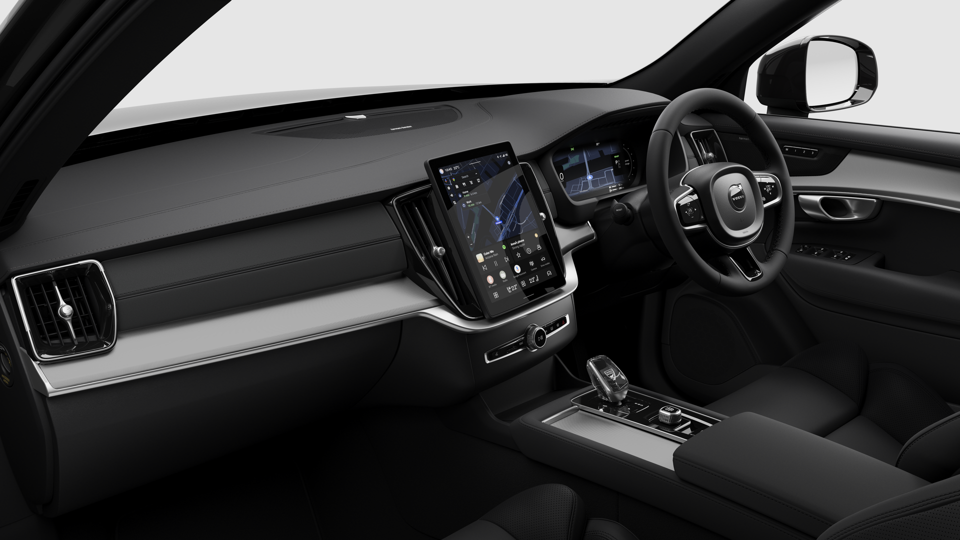 Interior view of a Volvo car showing the dashboard, steering wheel, center console, and digital display screen in a plain studio background.