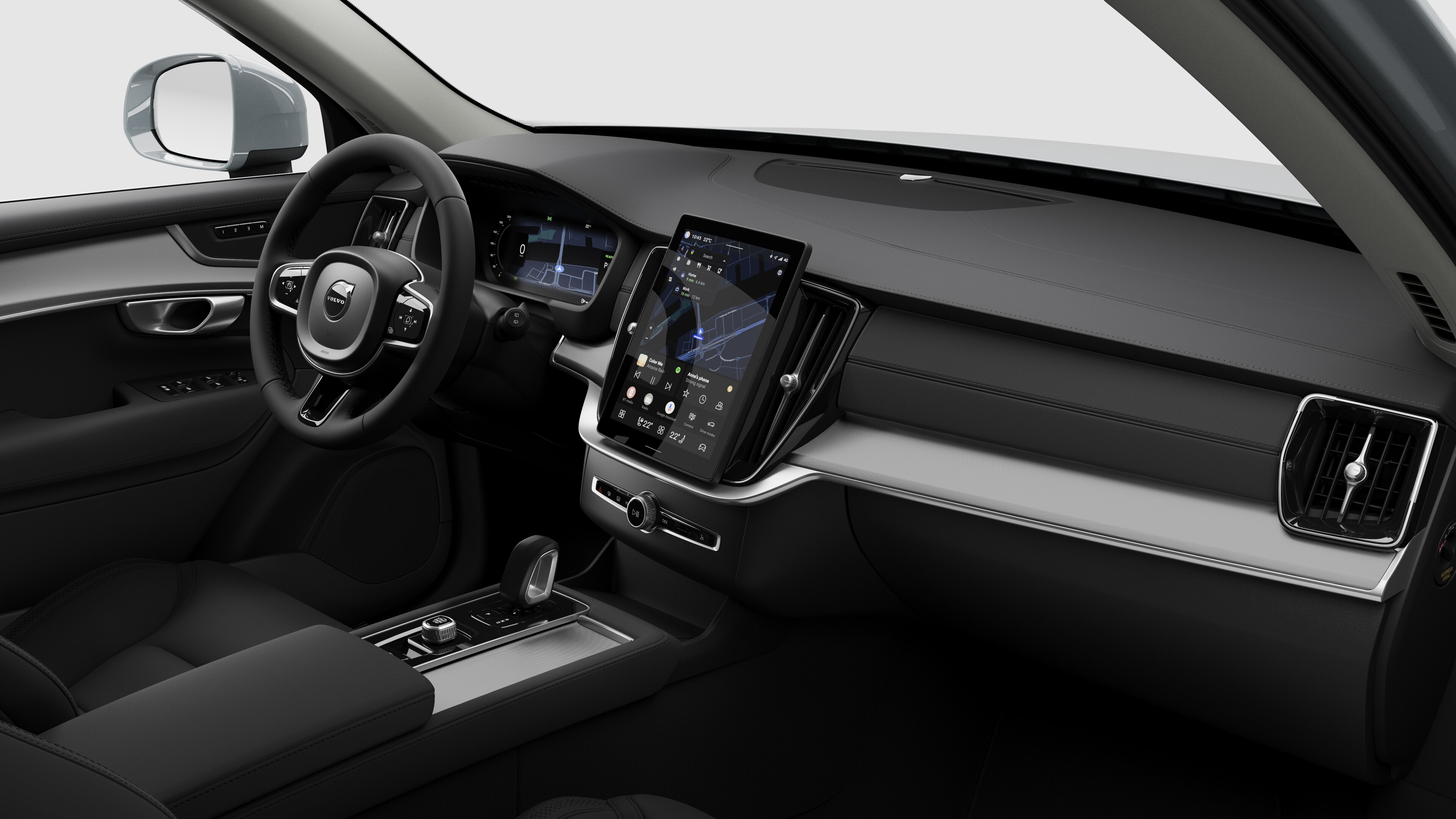 Binnenaanzicht van een Volvo met het dashboard, stuur, middenconsole en digitale display op een effen studioachtergrond.