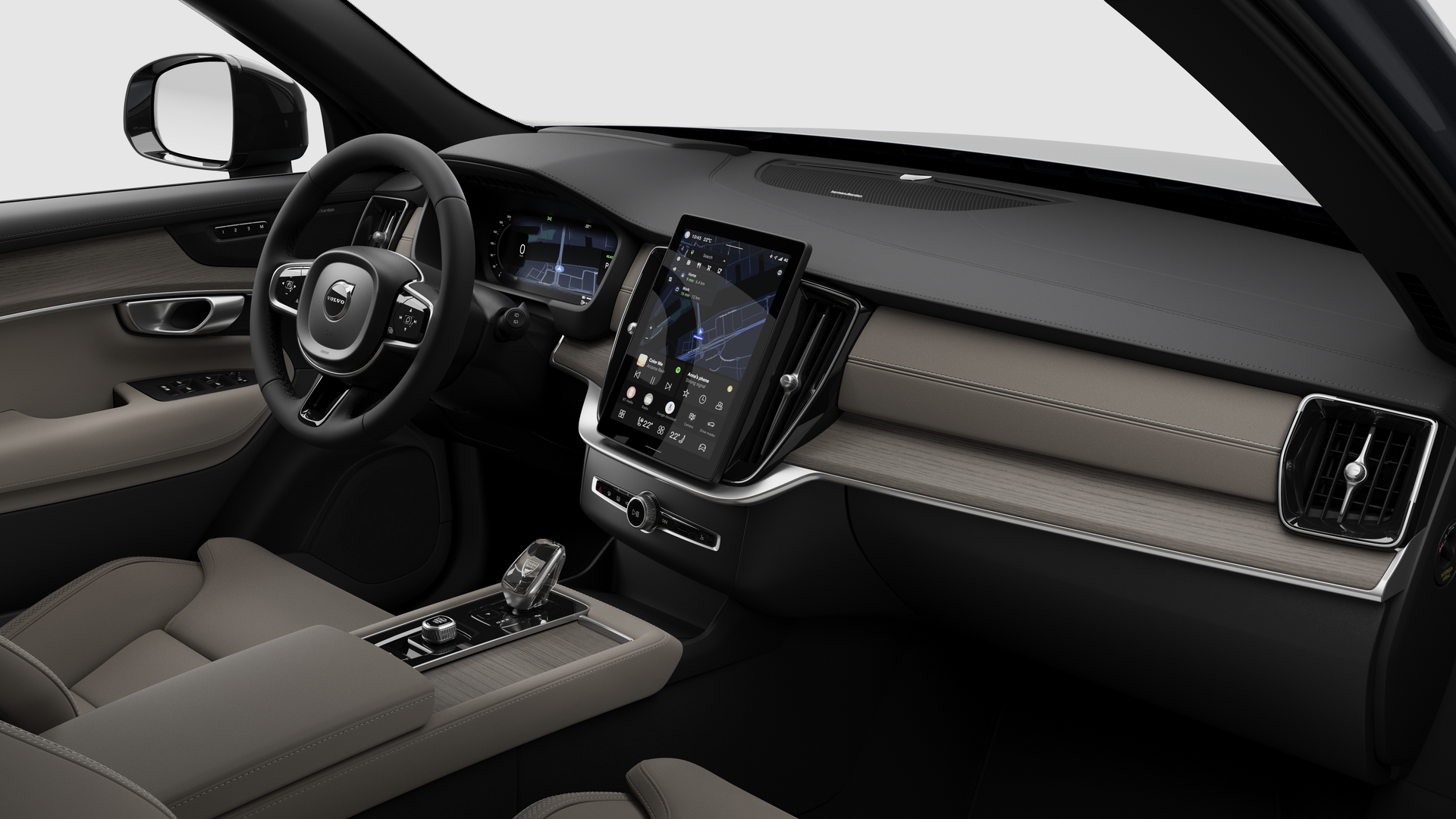 Vue intérieure d’une Volvo montrant le tableau de bord, le volant, la console centrale et l’écran d’affichage numérique sur un fond de studio uni.