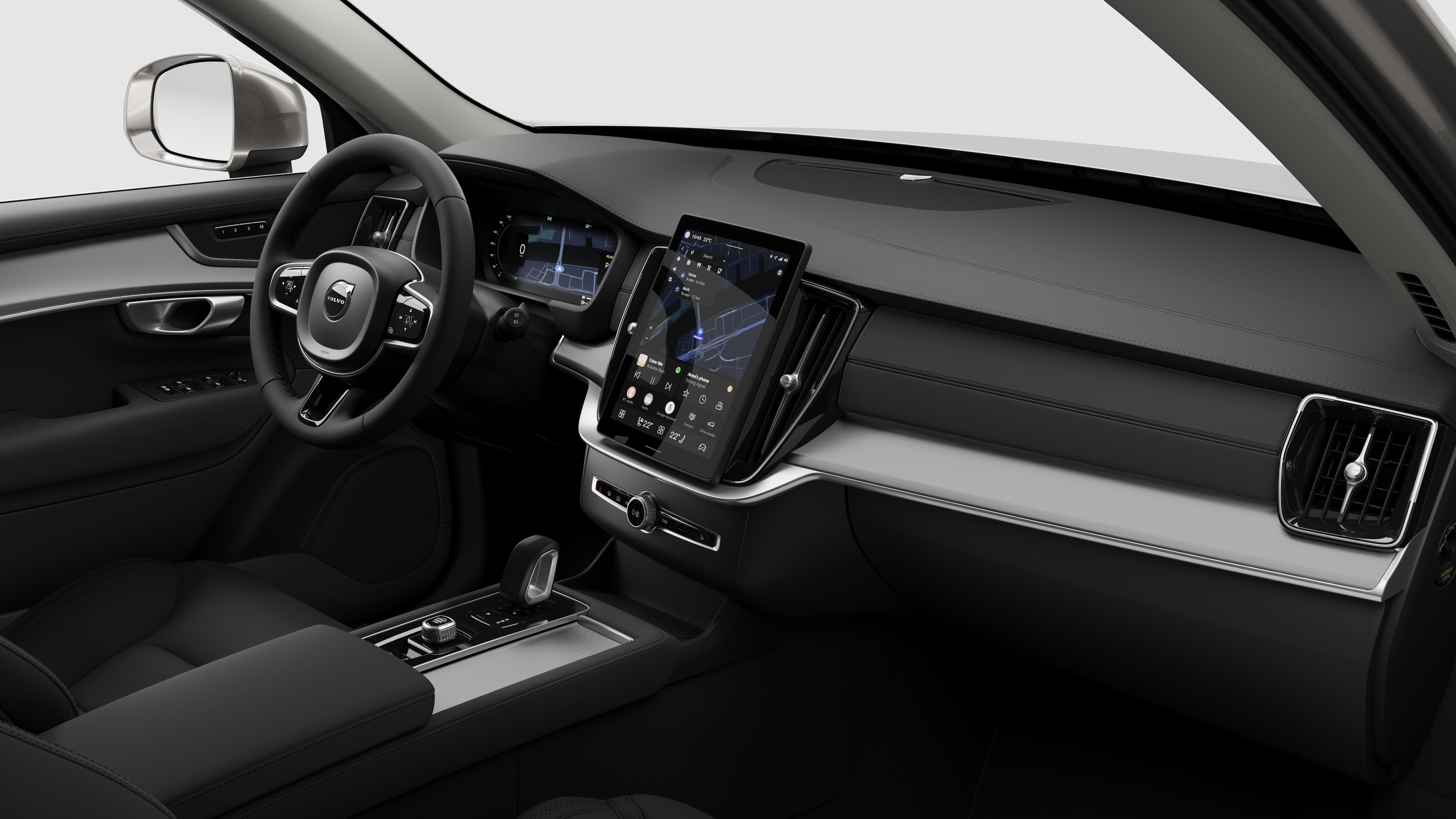 Vista interna di un'auto Volvo che mostra il cruscotto, il volante, la console centrale e lo schermo digitale sullo sfondo di uno studio.