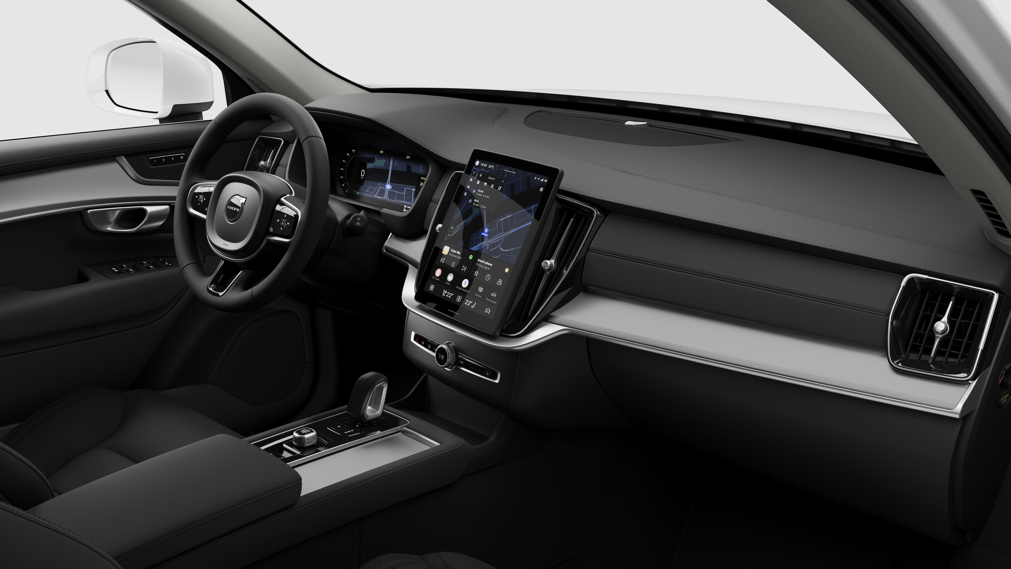 Vista interior de um automóvel Volvo a mostrar o painel de instrumentos, o volante, a consola central e o ecrã digital num fundo de estúdio simples.