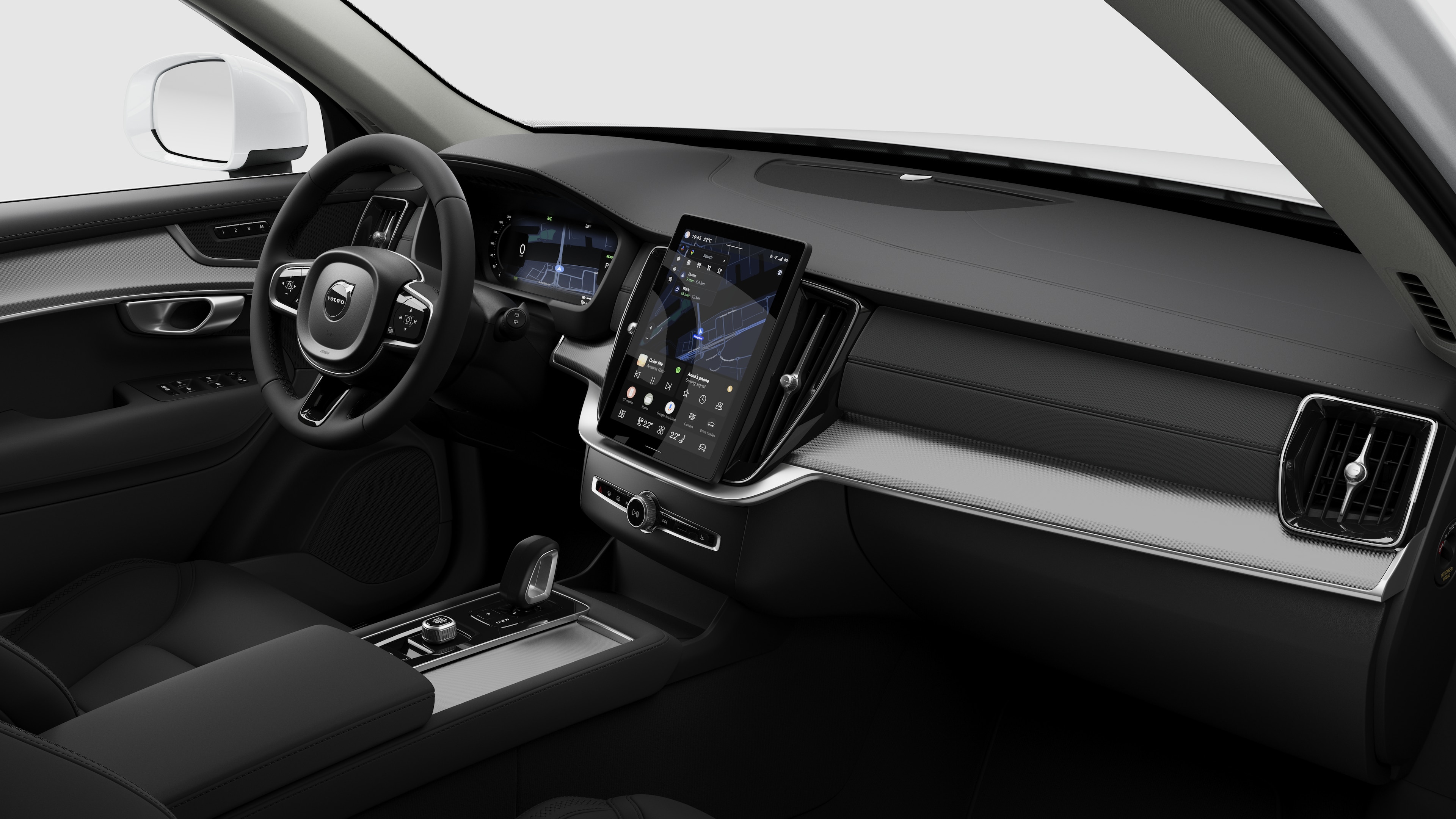 Vista interior de um automóvel Volvo a mostrar o painel de instrumentos, o volante, a consola central e o ecrã digital num fundo de estúdio simples.