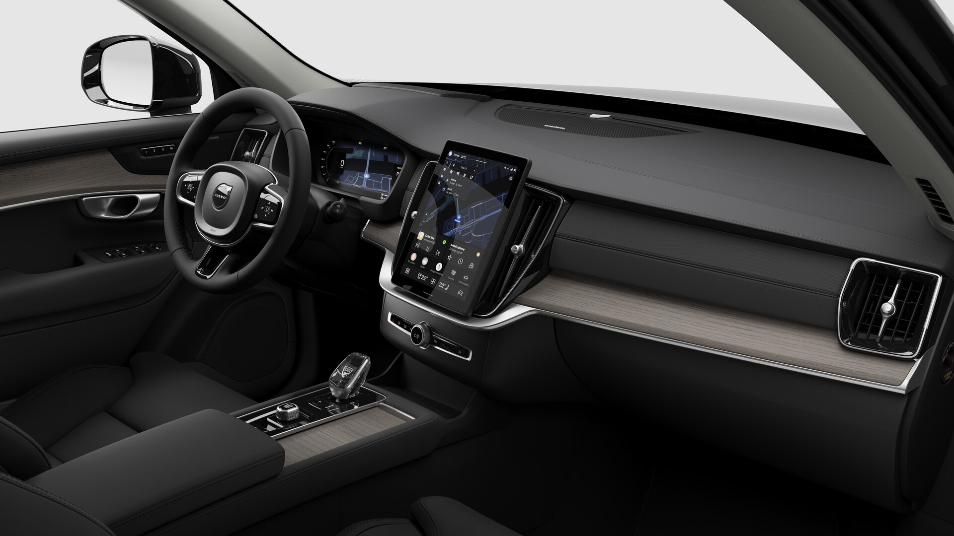 Vue intérieure d’une Volvo montrant le tableau de bord, le volant, la console centrale et l’écran d’affichage numérique sur un fond de studio uni.
