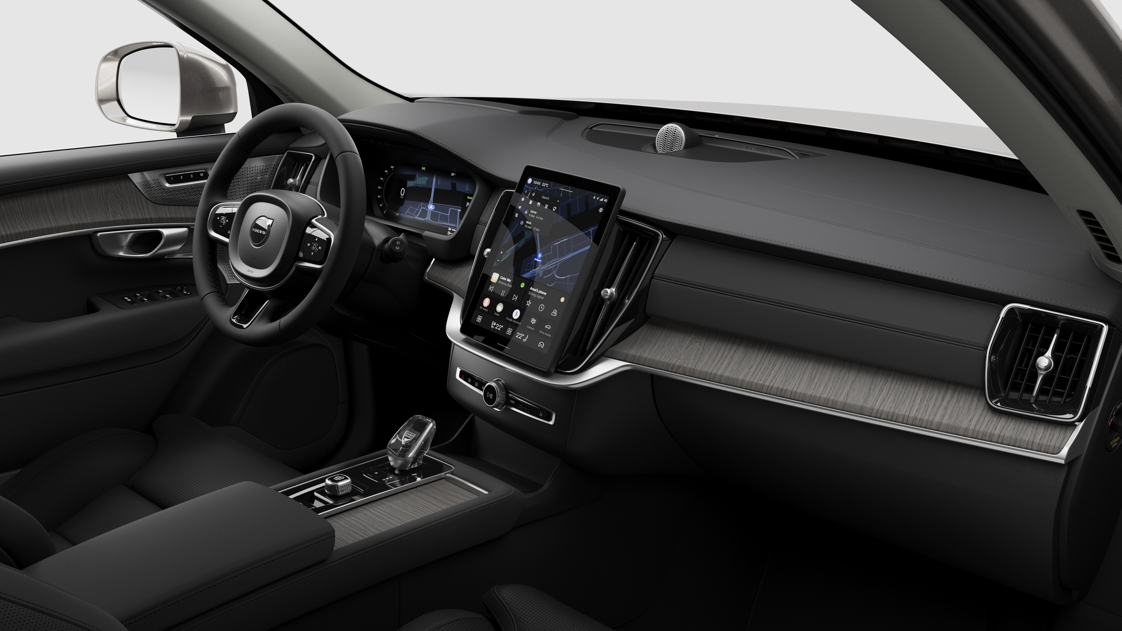 Volvo 汽車的內部視圖，以純色工作室背景顯示儀錶板、方向盤、中控台和數字顯示幕。