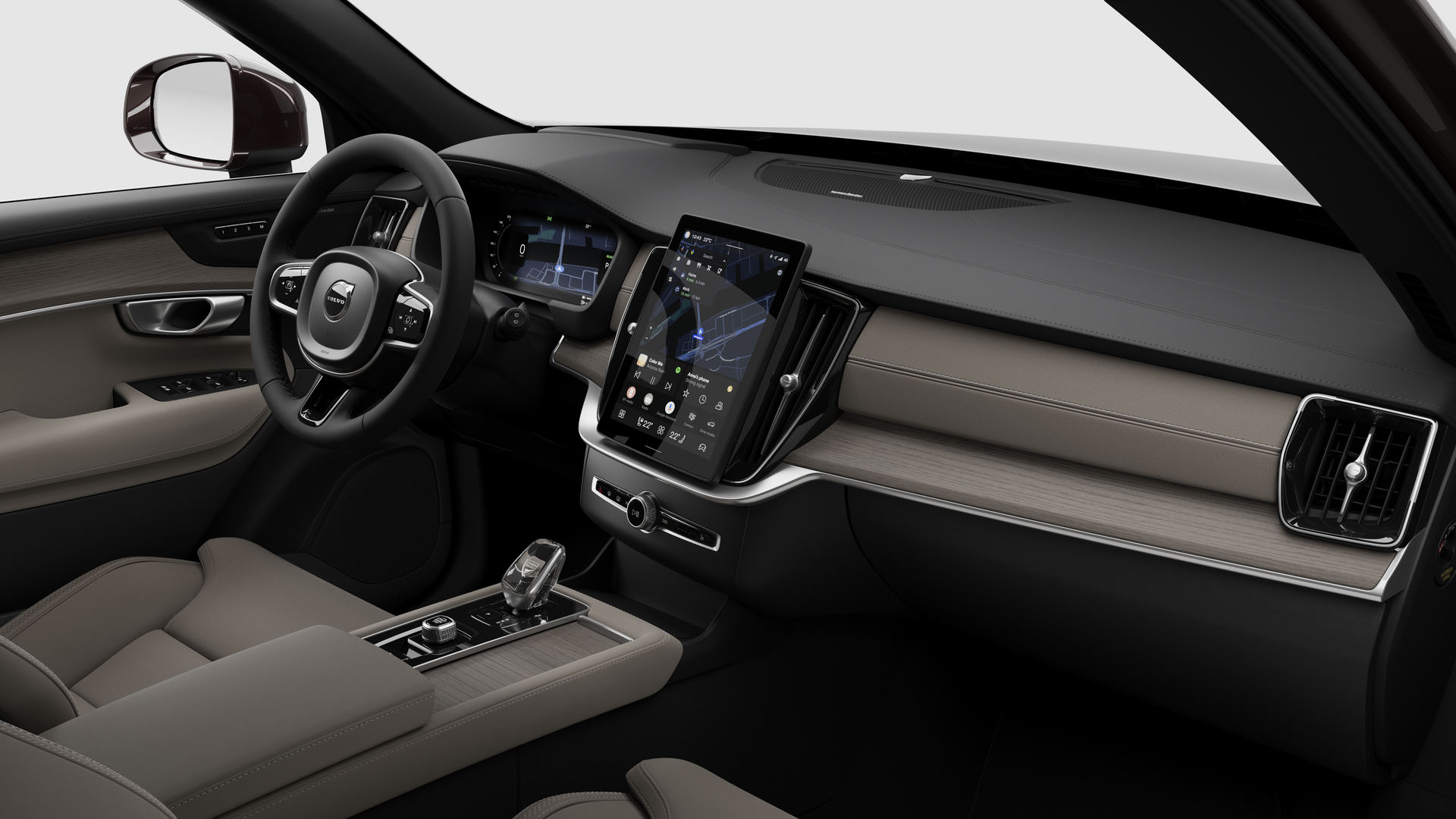 Vue intérieure d’une Volvo montrant le tableau de bord, le volant, la console centrale et l’écran d’affichage numérique sur un fond de studio uni.