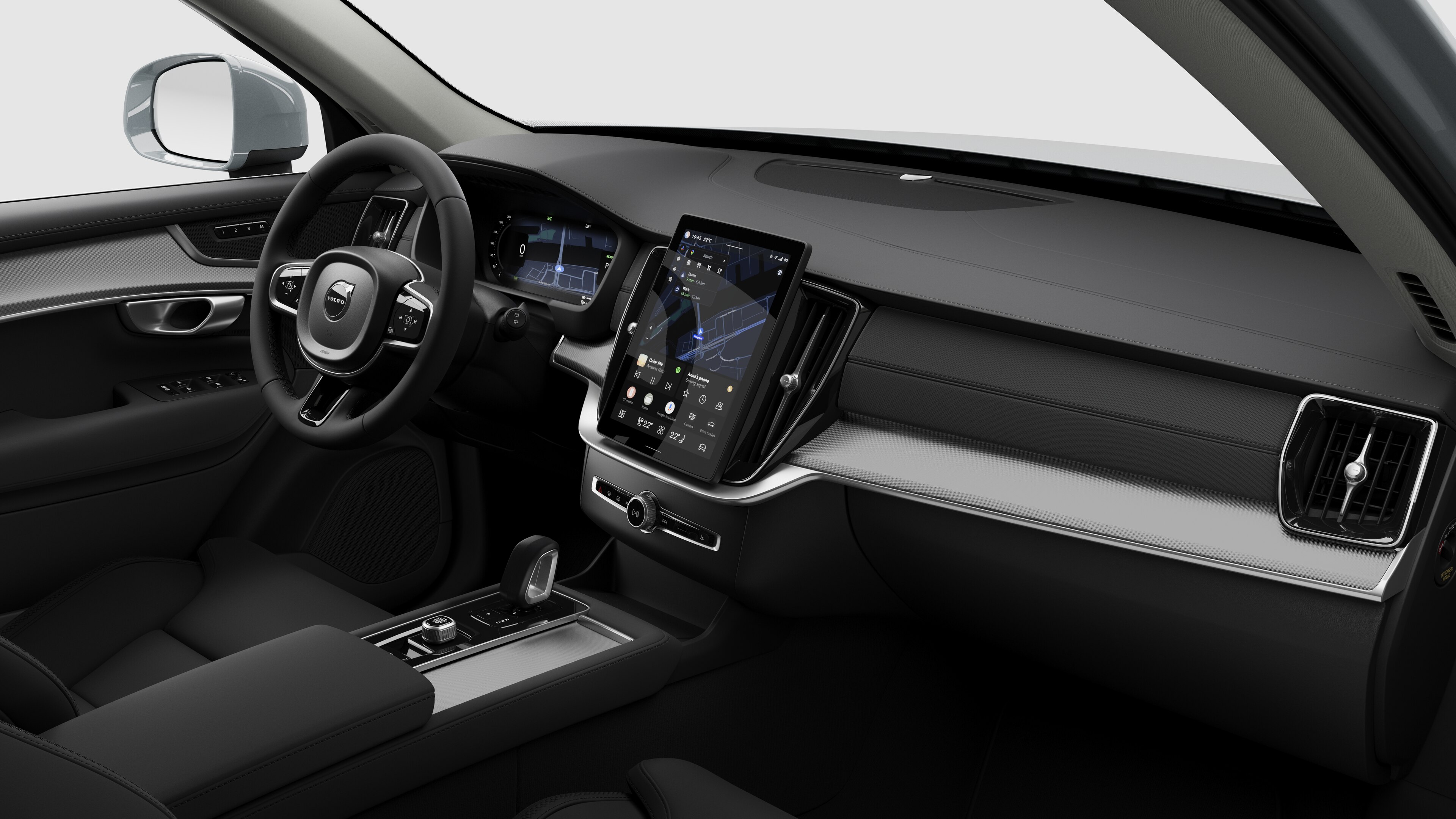 Vue intérieure d’une Volvo montrant le tableau de bord, le volant, la console centrale et l’écran d’affichage numérique sur un fond de studio uni.