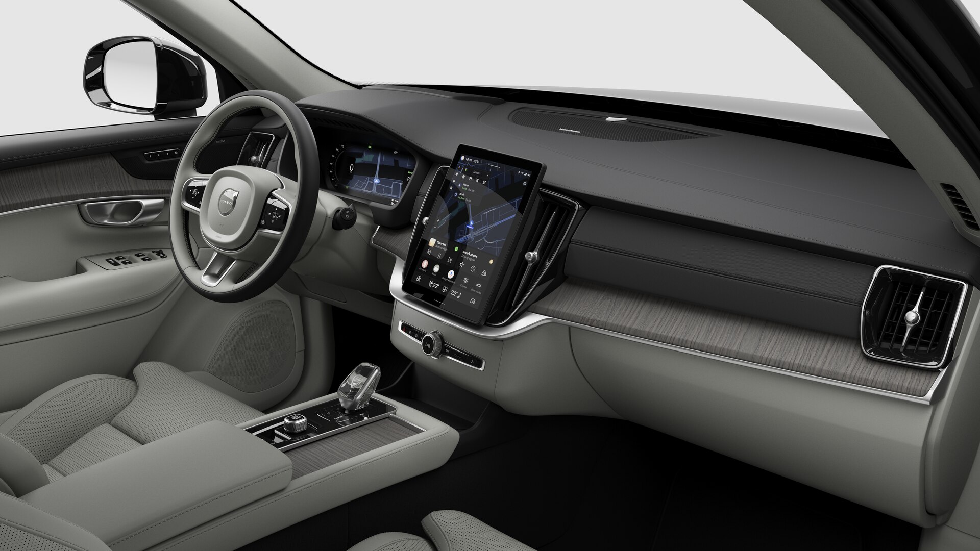 Vue intérieure d’une Volvo montrant le tableau de bord, le volant, la console centrale et l’écran d’affichage numérique sur un fond de studio uni.