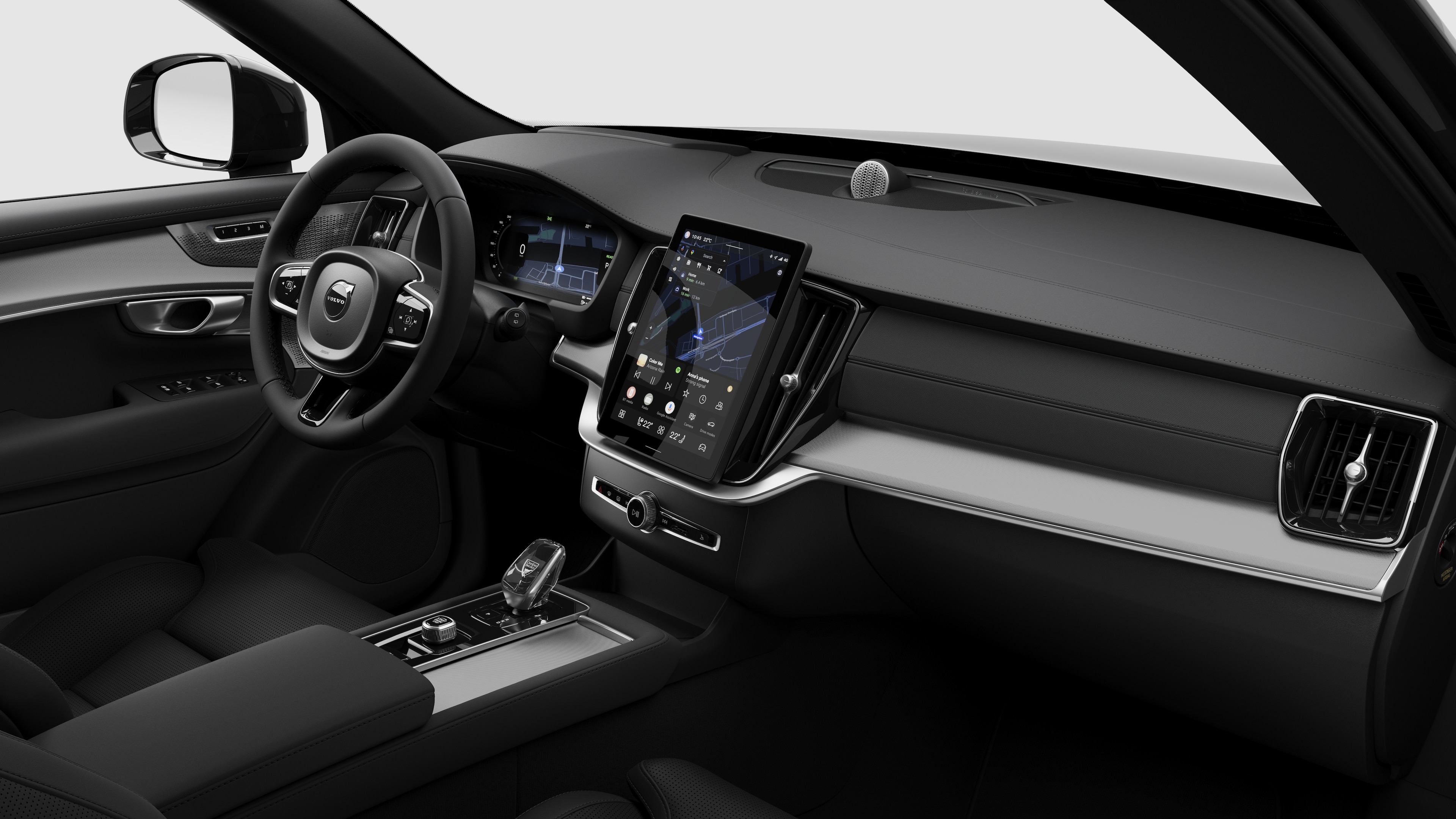 Binnenaanzicht van een Volvo met het dashboard, het stuur, de middenconsole en het digitale beeldscherm in een effen studioachtergrond.