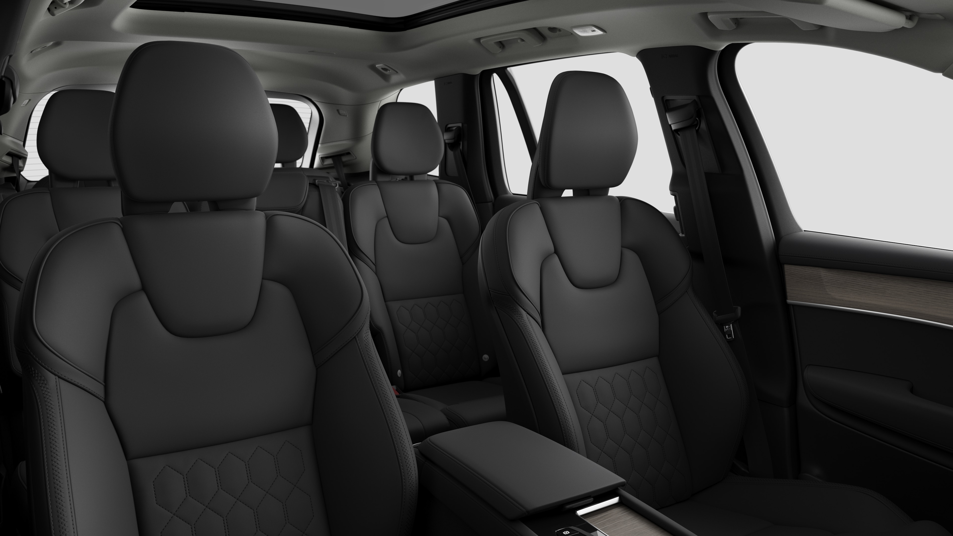 Volvo car interior showing rear passenger seats and center console in plain studio background.