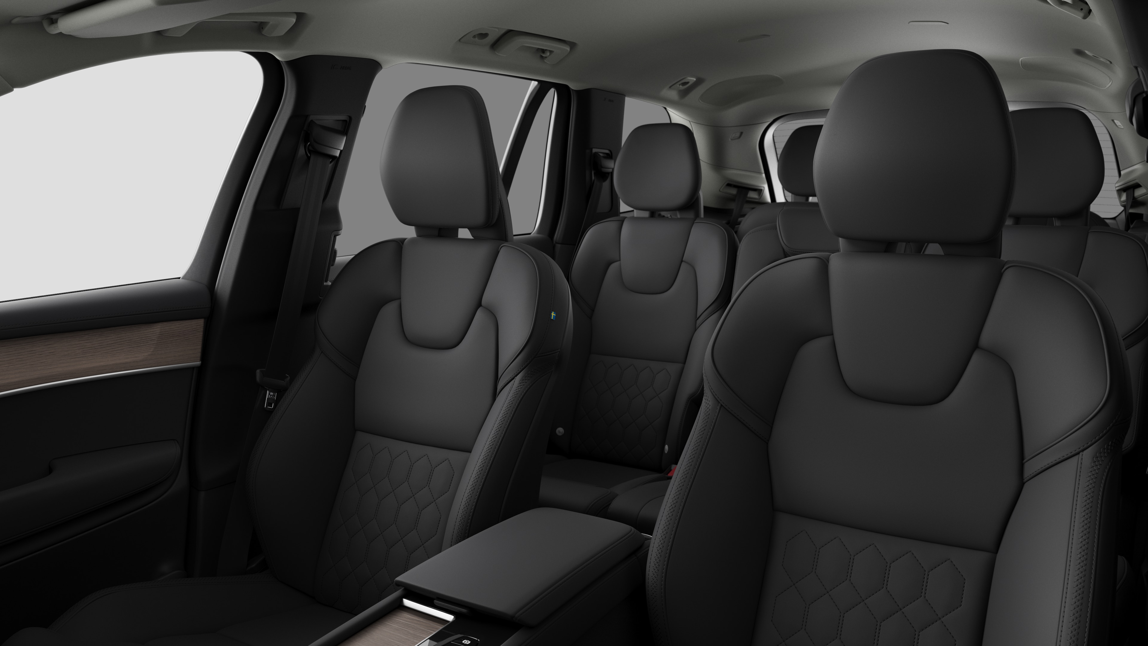 Intérieur d’une Volvo montrant les sièges passager arrière et la console centrale en arrière-plan de studio.