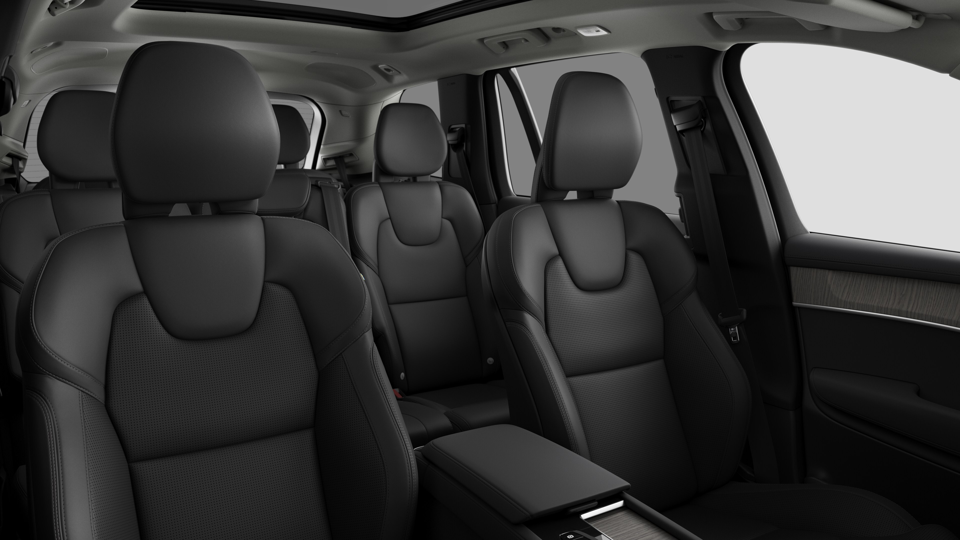Volvo car interior showing rear passenger seats and center console in plain studio background.