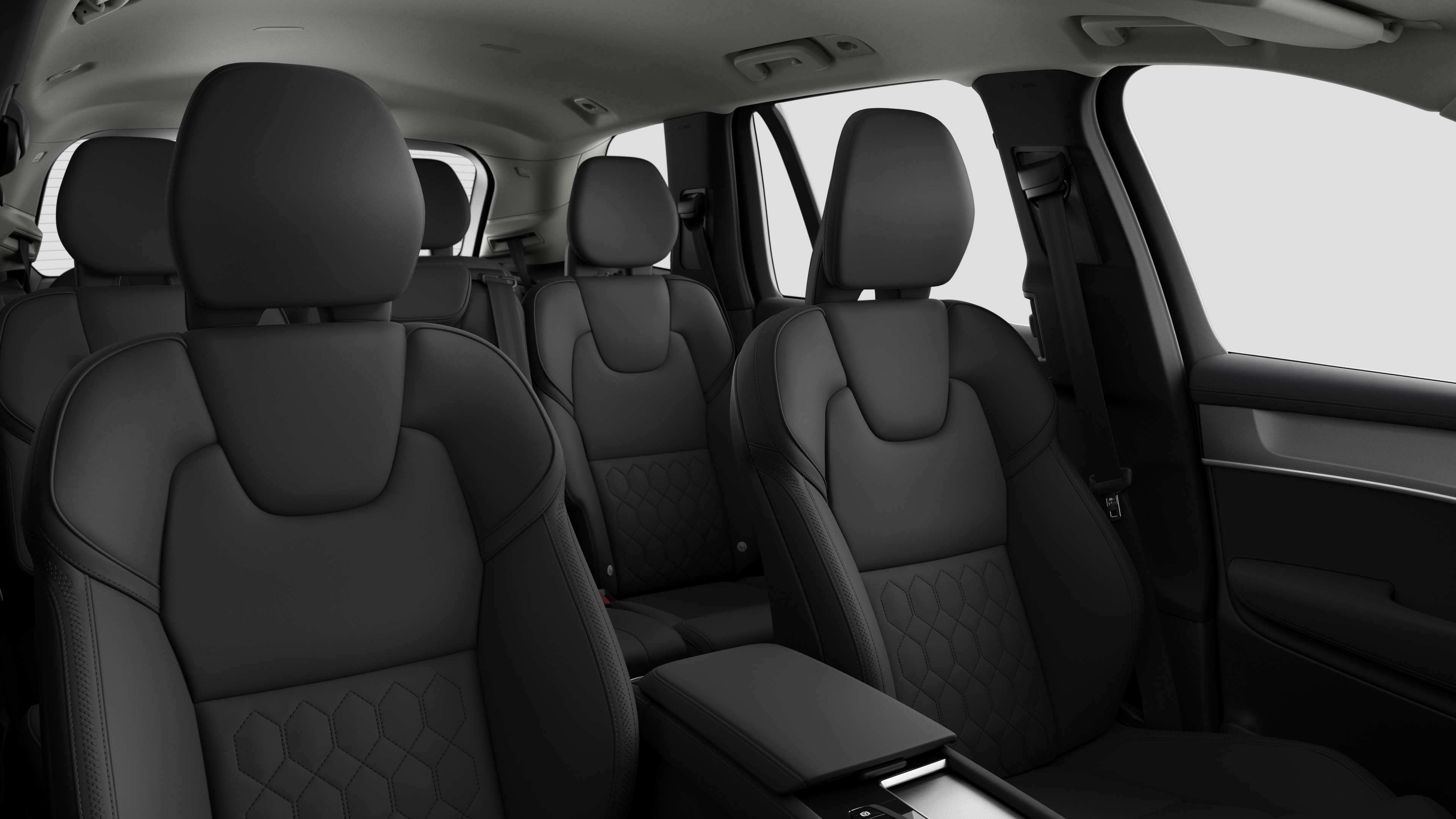 Volvo car interior showing rear passenger seats and center console in plain studio background.