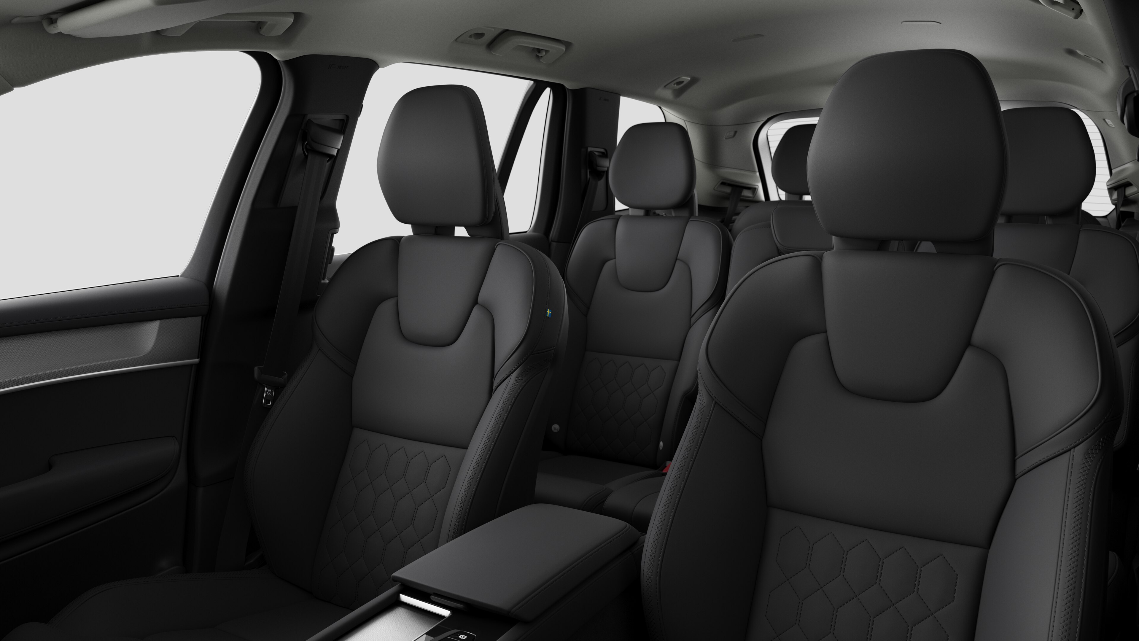 Intérieur d’une Volvo montrant les sièges passager arrière et la console centrale en arrière-plan de studio.