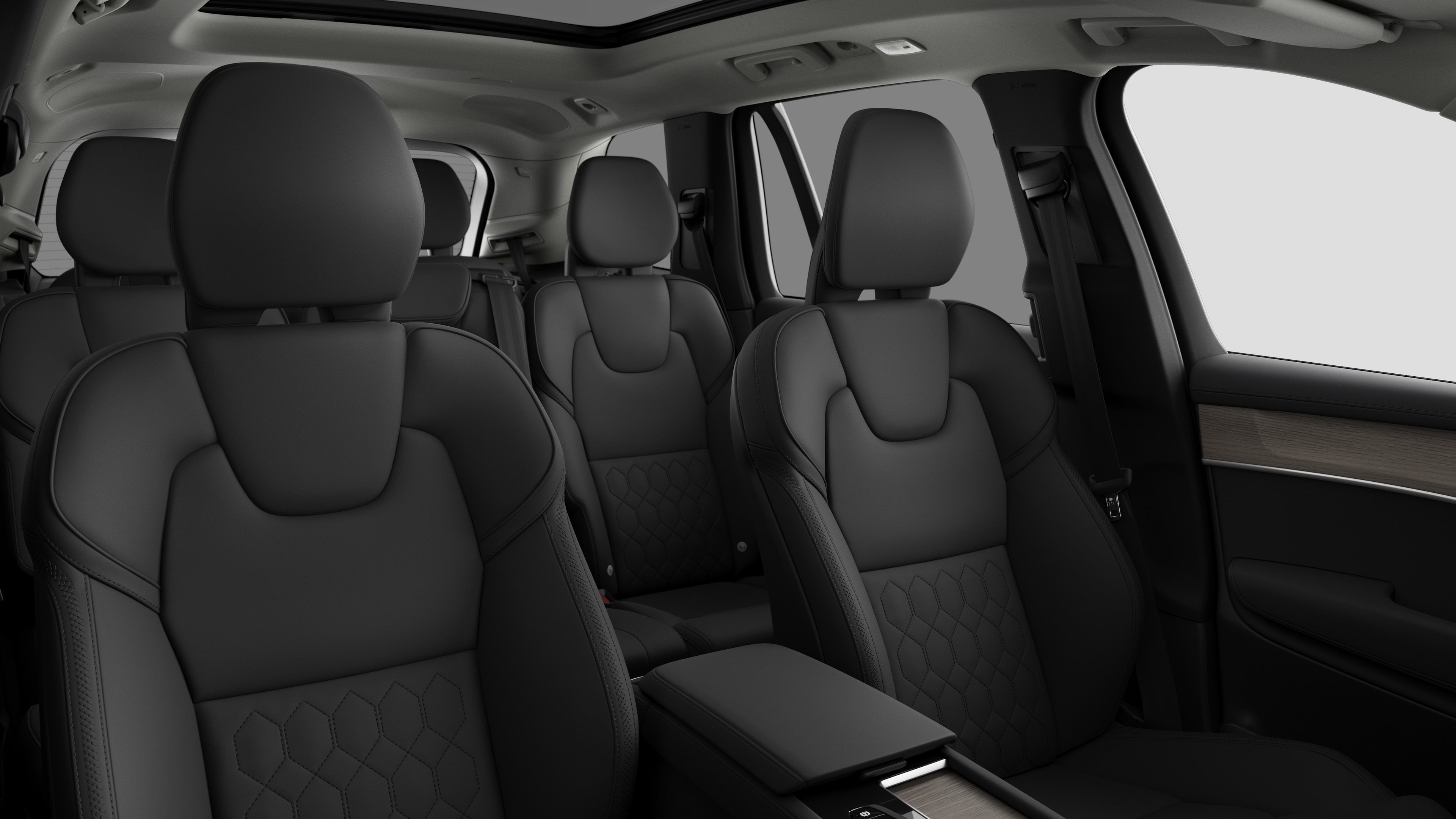 Volvo car interior showing rear passenger seats and center console in plain studio background.
