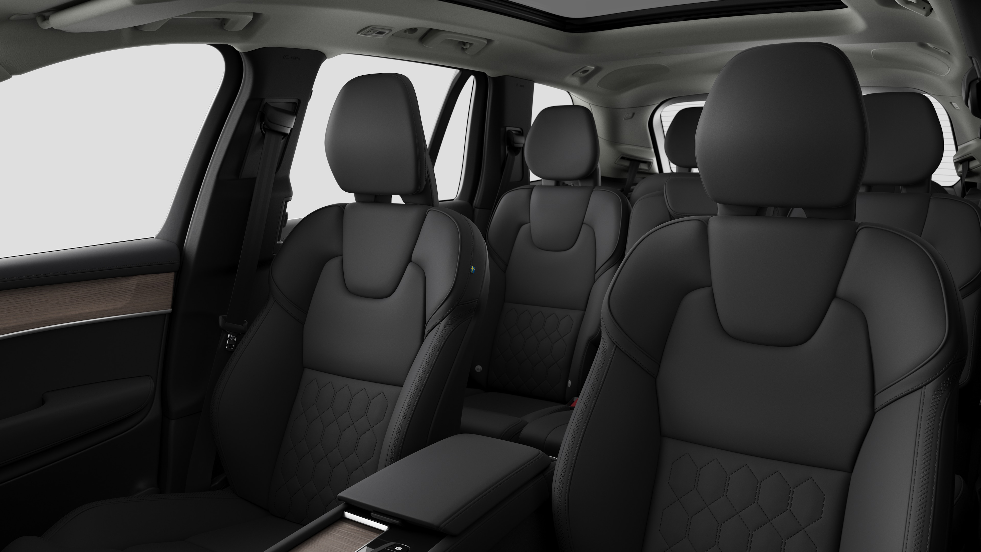 Volvo-bilinteriør med passagersæder bagtil og midterkonsol i almindelig studiebaggrund.
