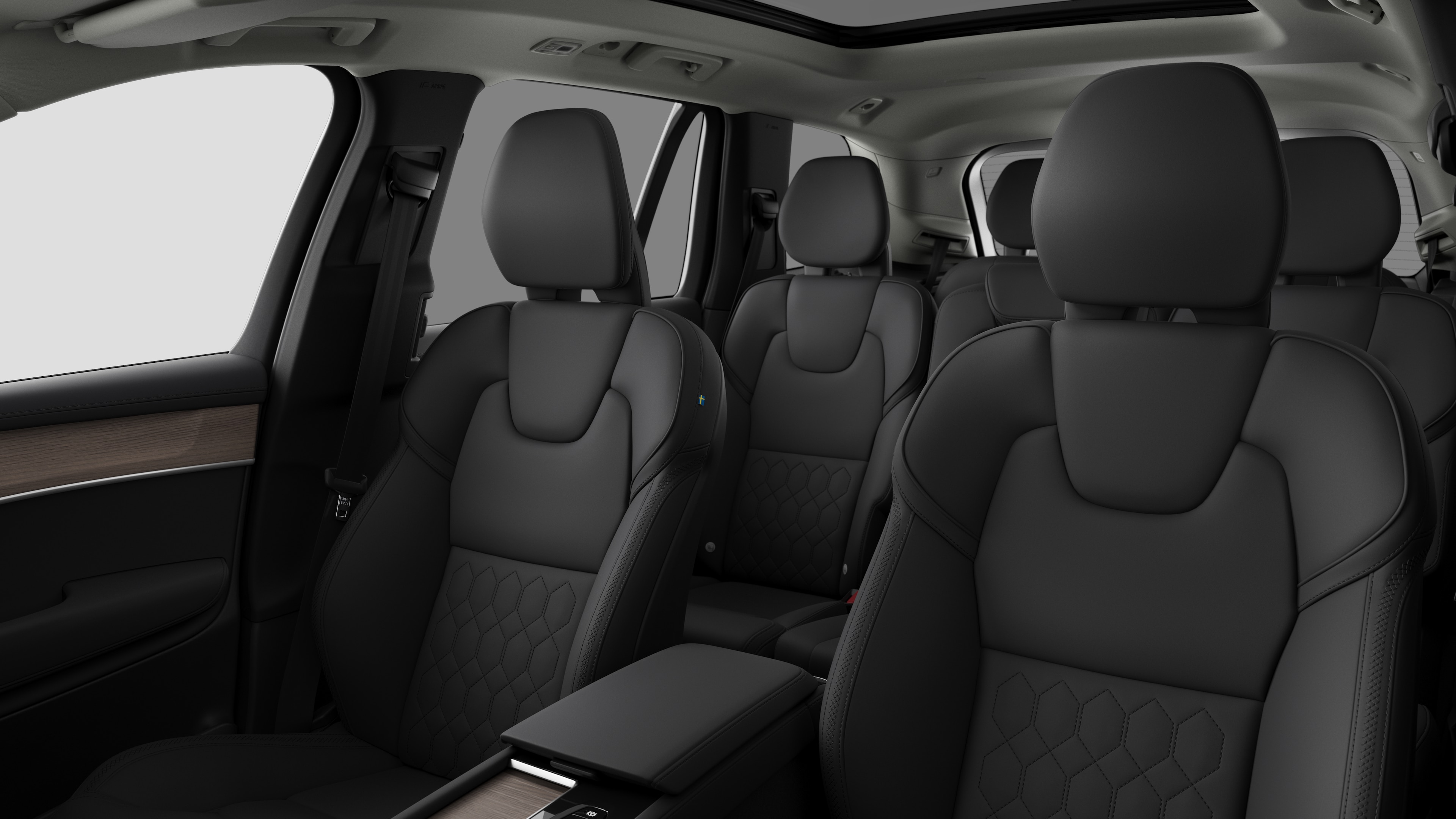 Volvo car interior showing rear passenger seats and center console in plain studio background.