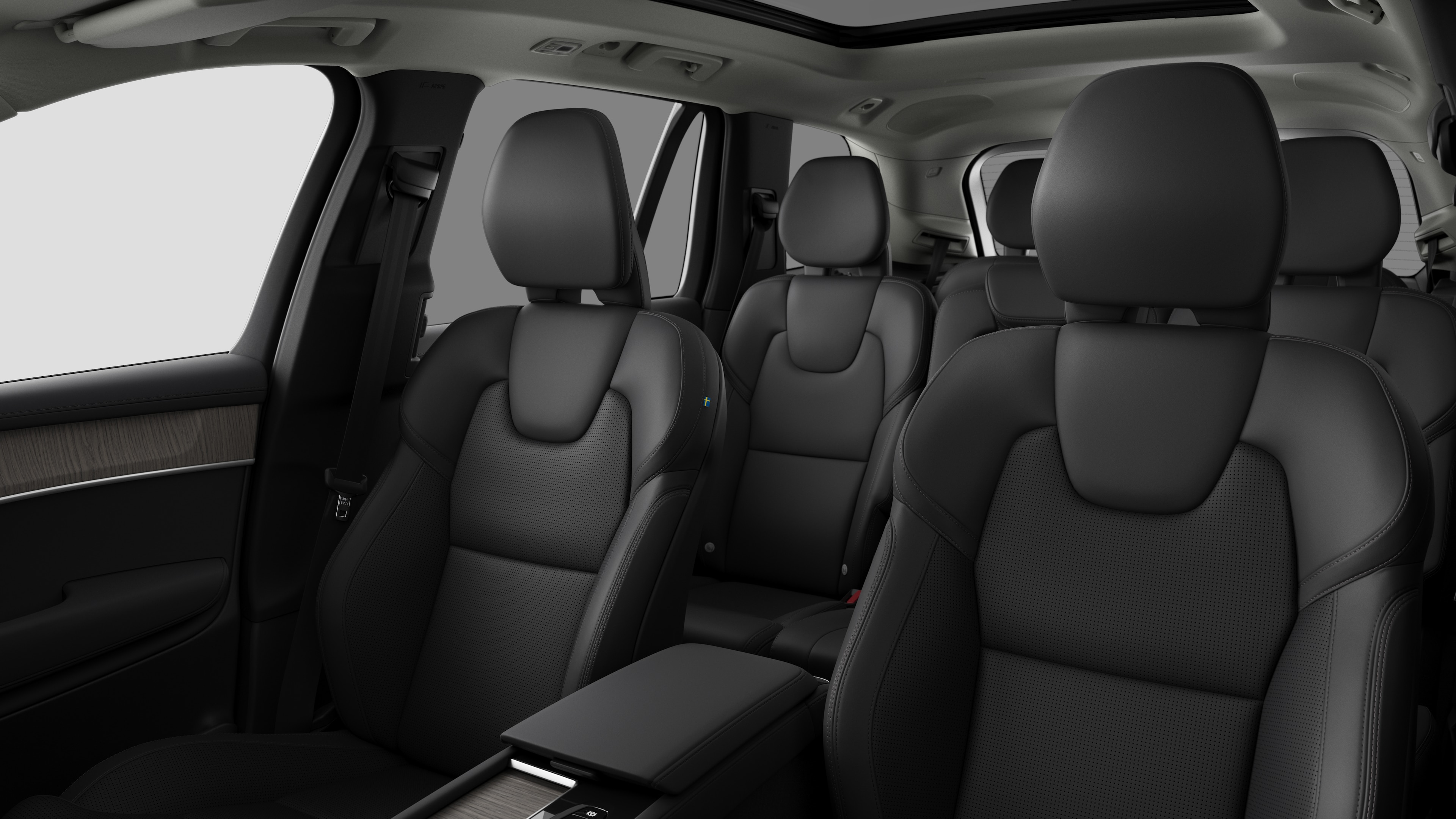 Volvo car interior showing rear passenger seats and center console in plain studio background.