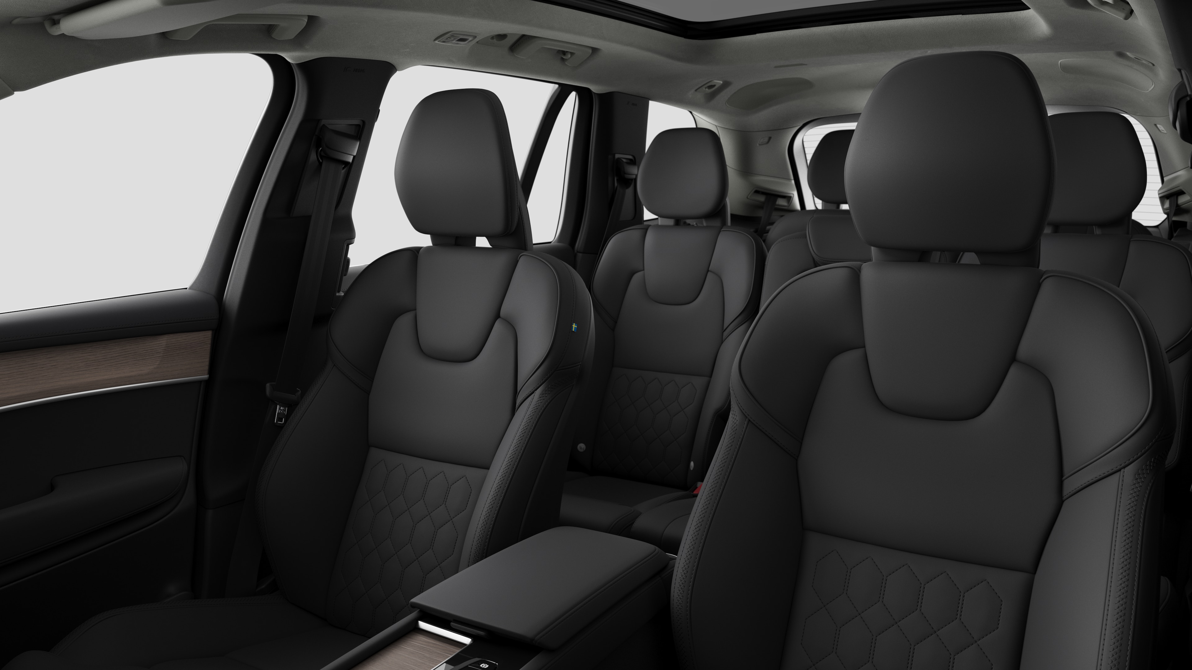 Volvo car interior showing rear passenger seats and center console in plain studio background.