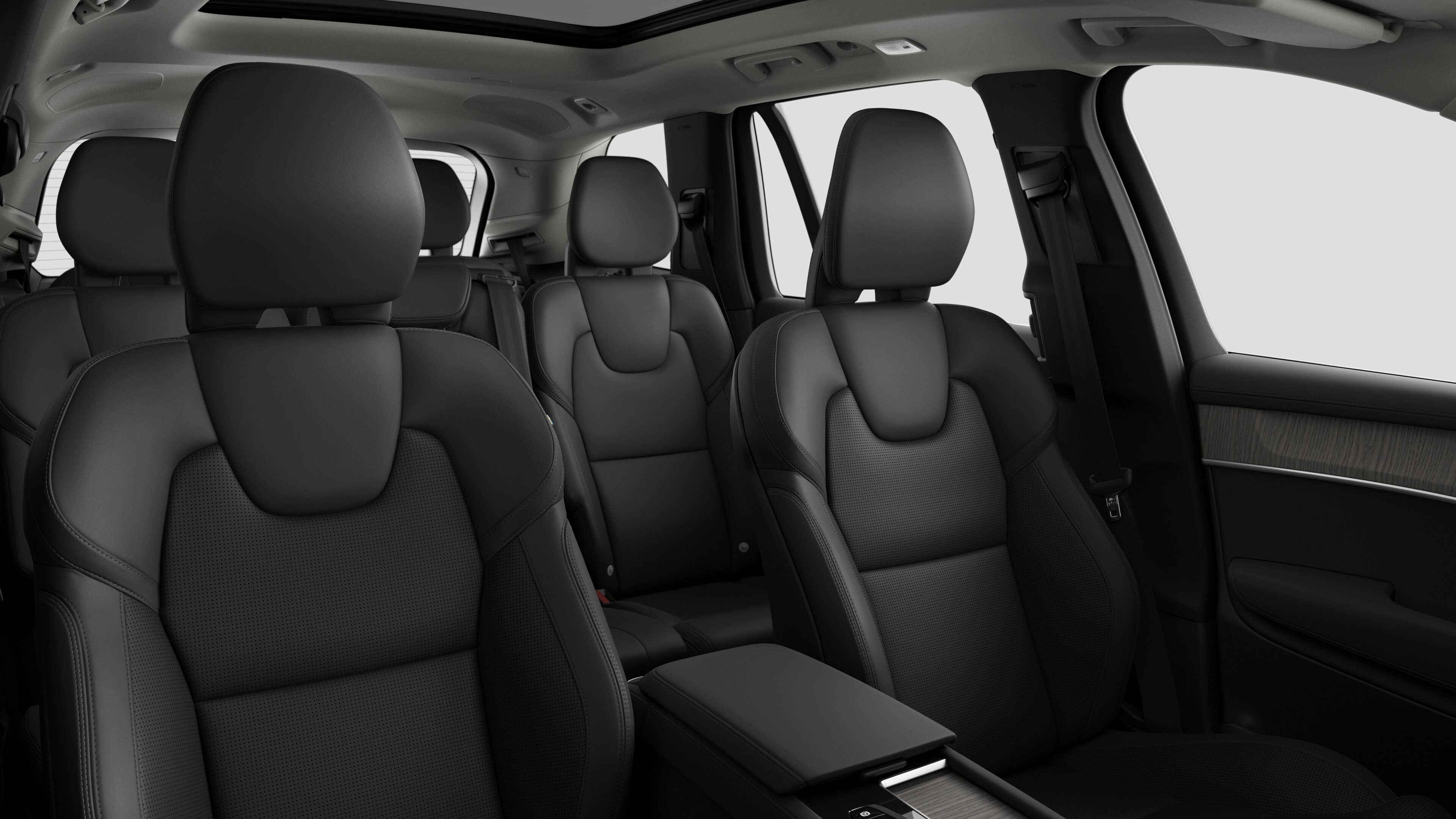 Volvo car interior showing rear passenger seats and center console in plain studio background.