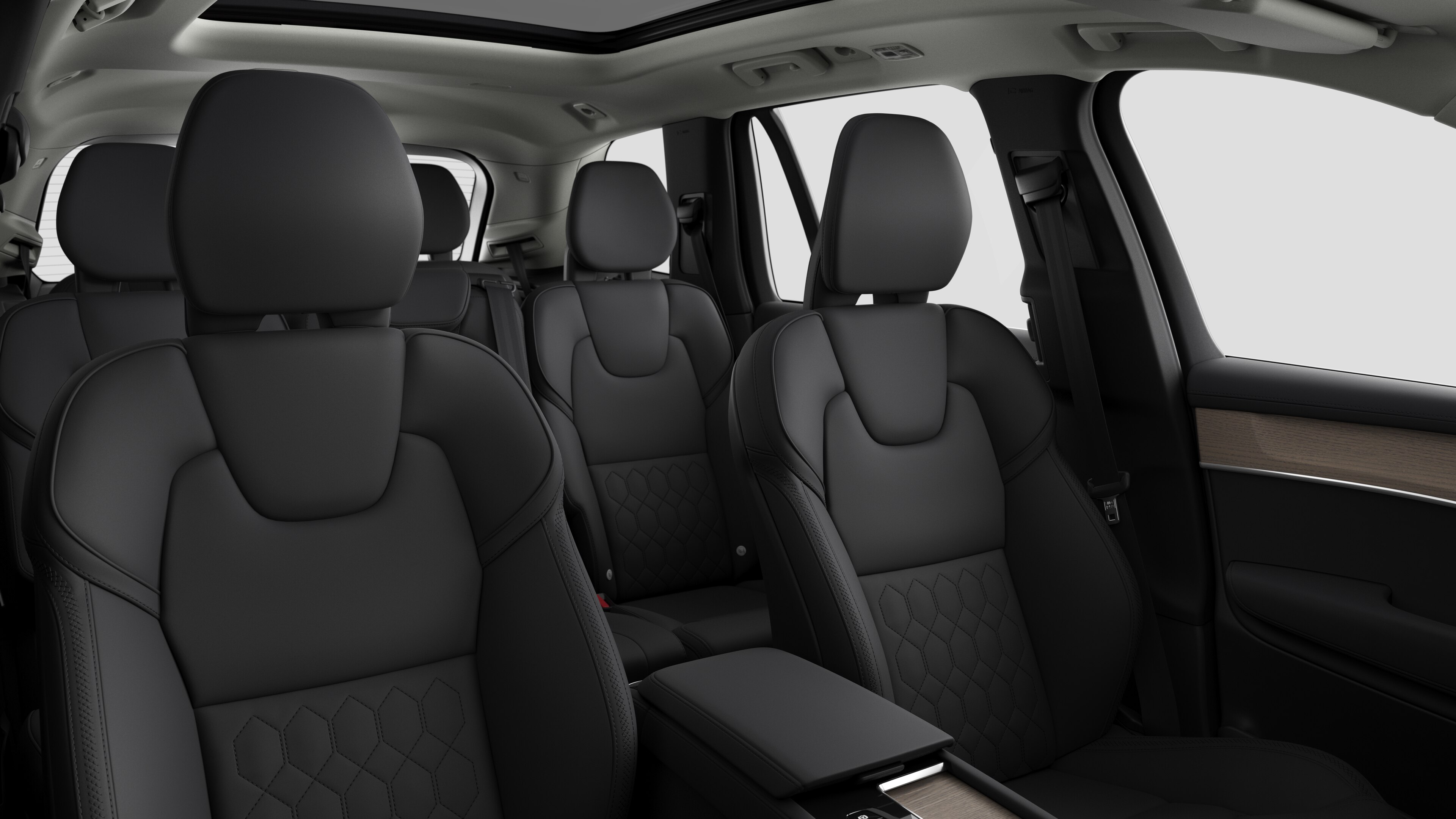 Volvo car interior showing rear passenger seats and center console in plain studio background.