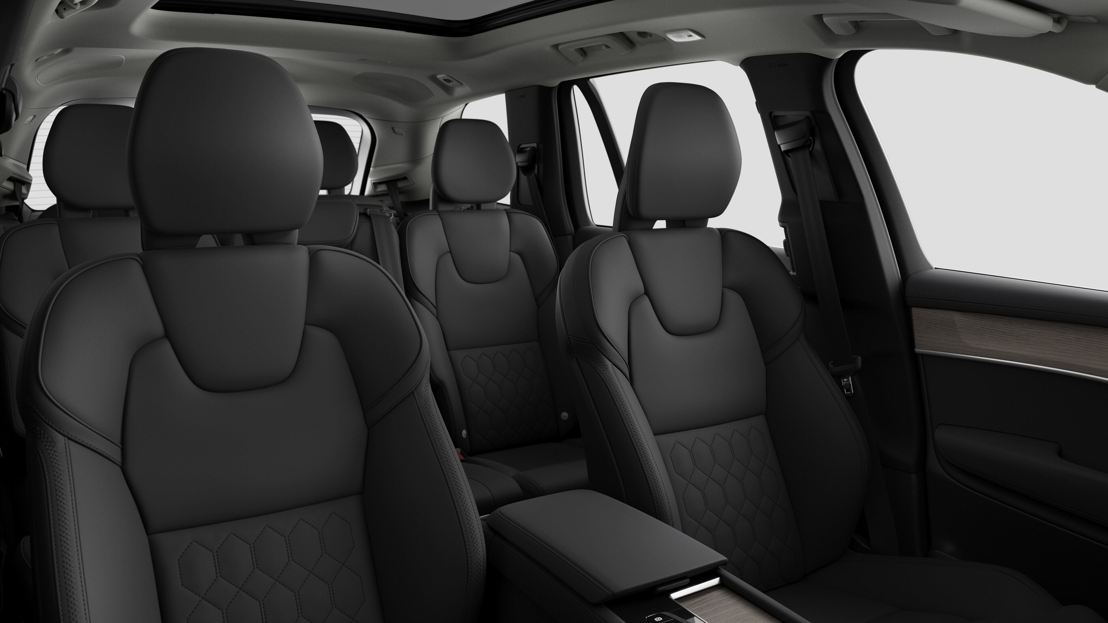 Volvo car interior showing rear passenger seats and center console in plain studio background.