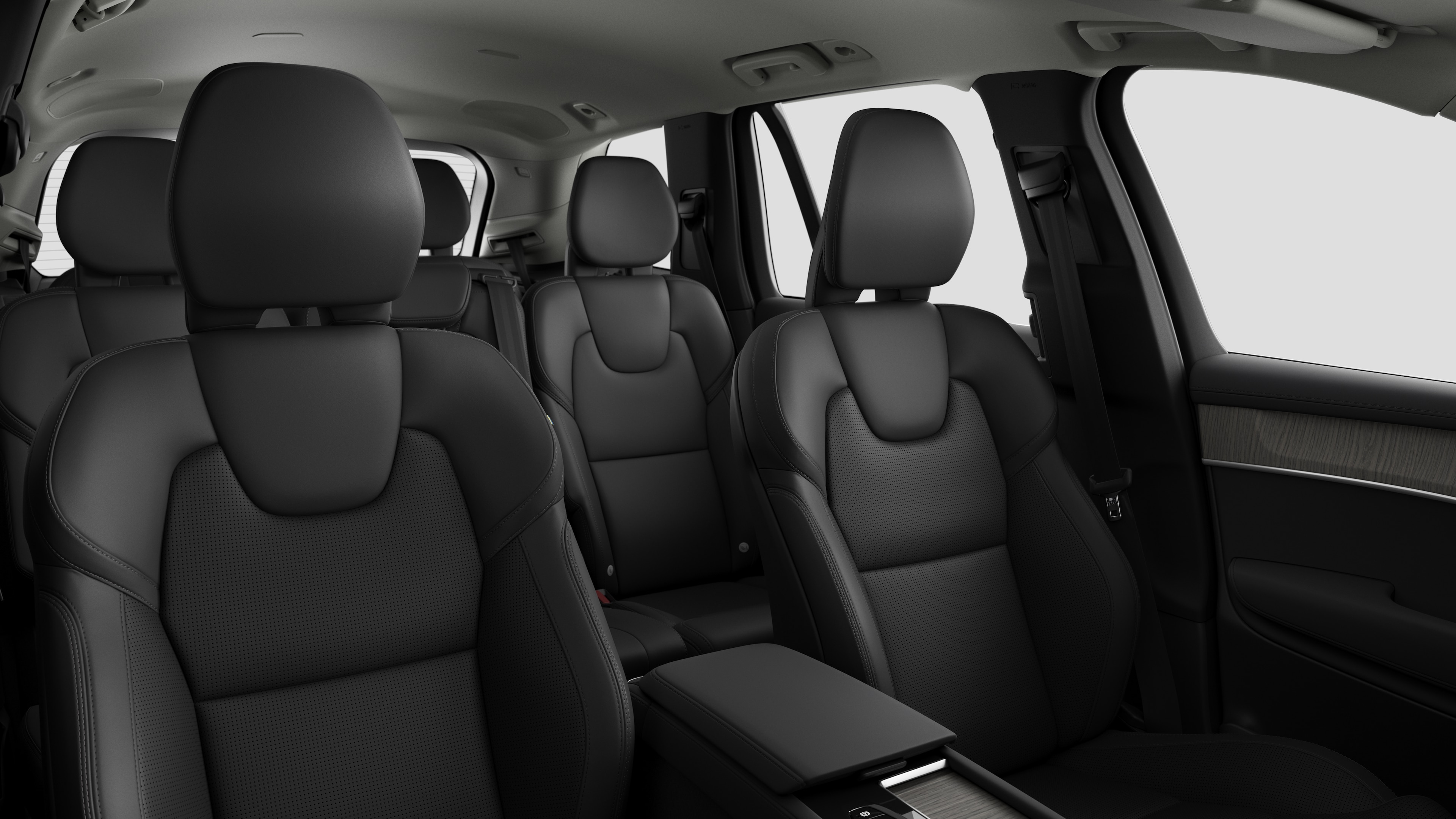 Volvo car interior showing rear passenger seats and center console in plain studio background.