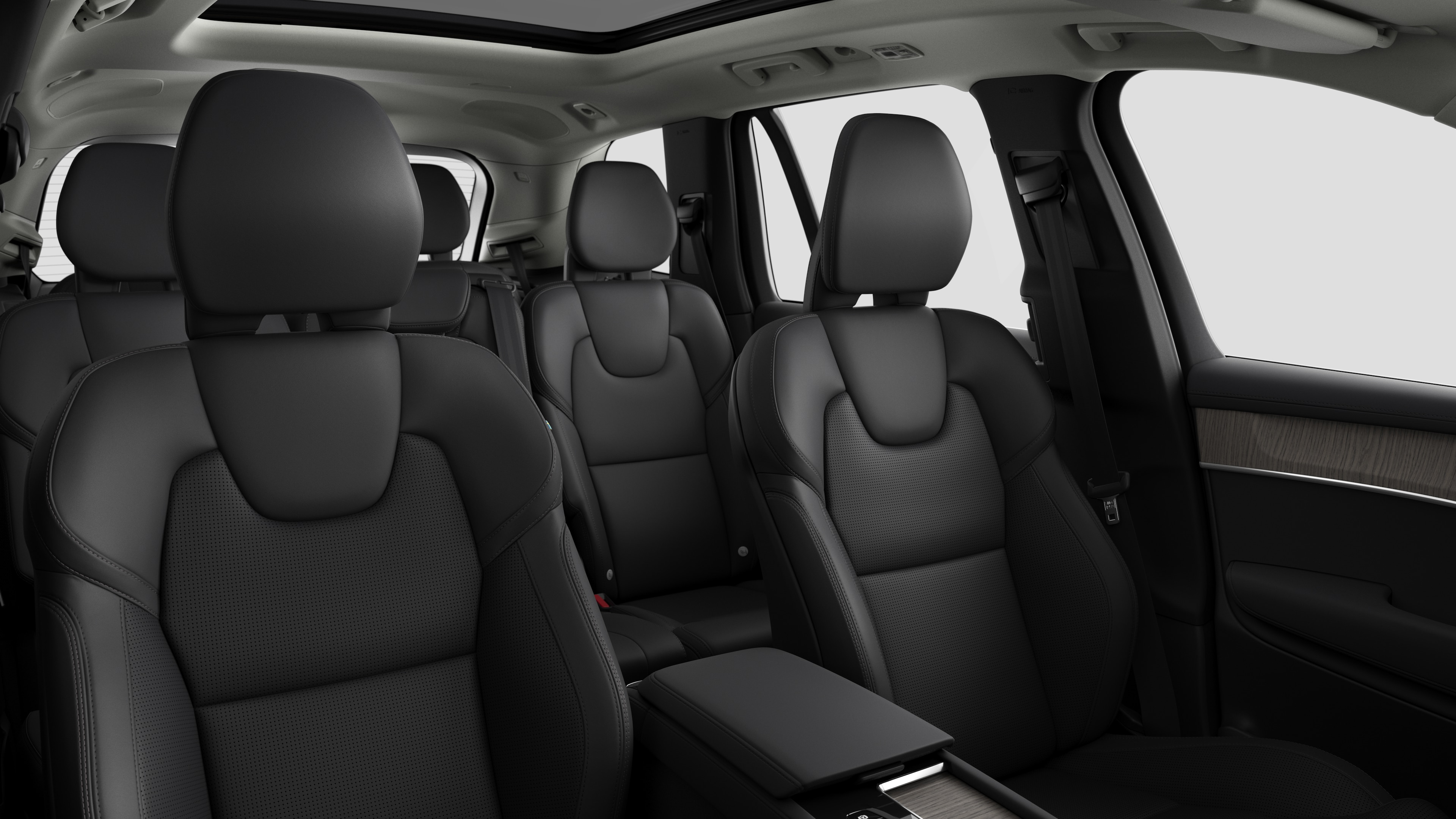 Volvo car interior showing rear passenger seats and center console in plain studio background.