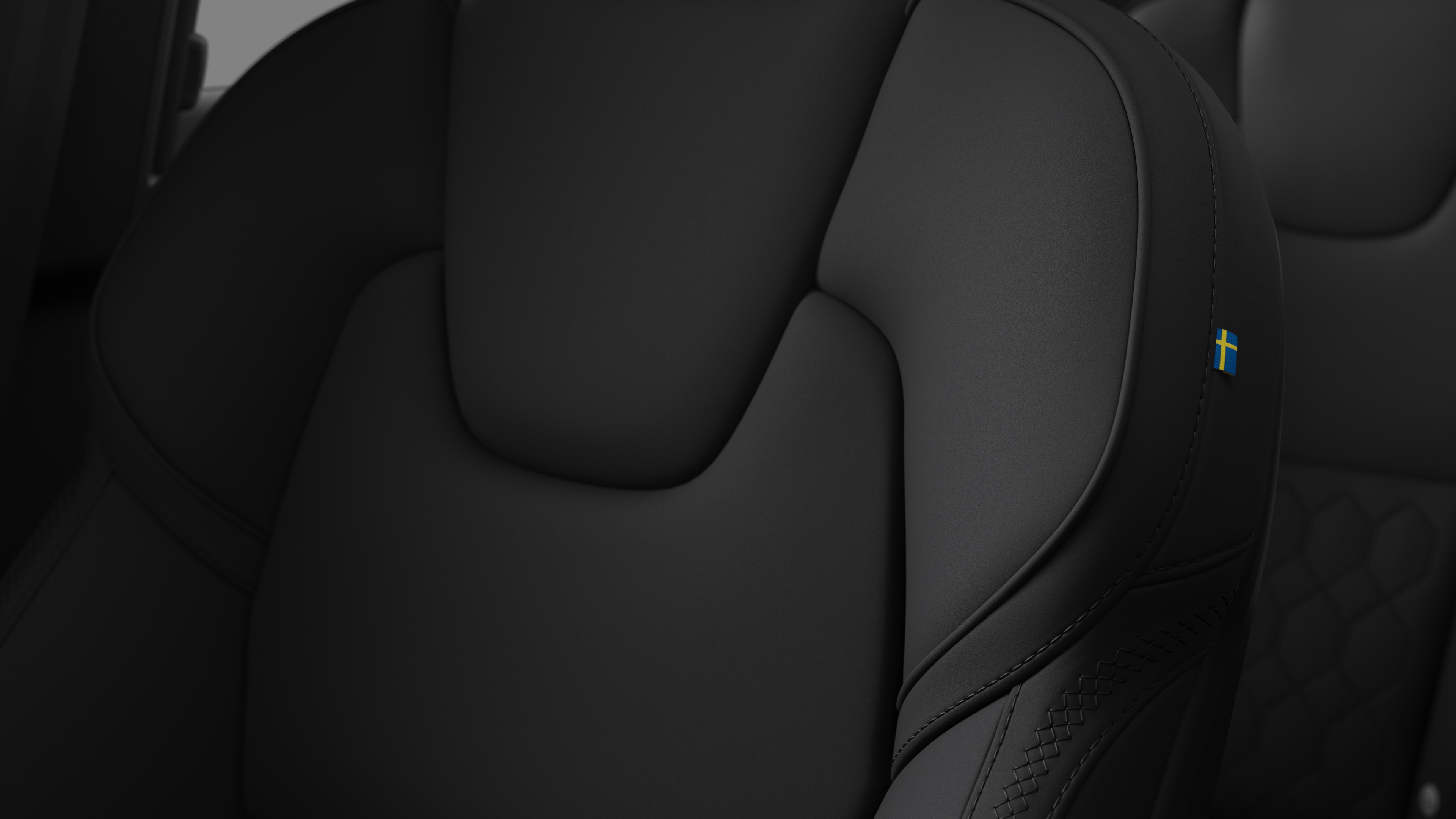 Yapışqanlıq və kiçik İsveç bayrağı etiketini göstərən Volvo avtomobil daxili oturacaq detalının yaxınlığı.